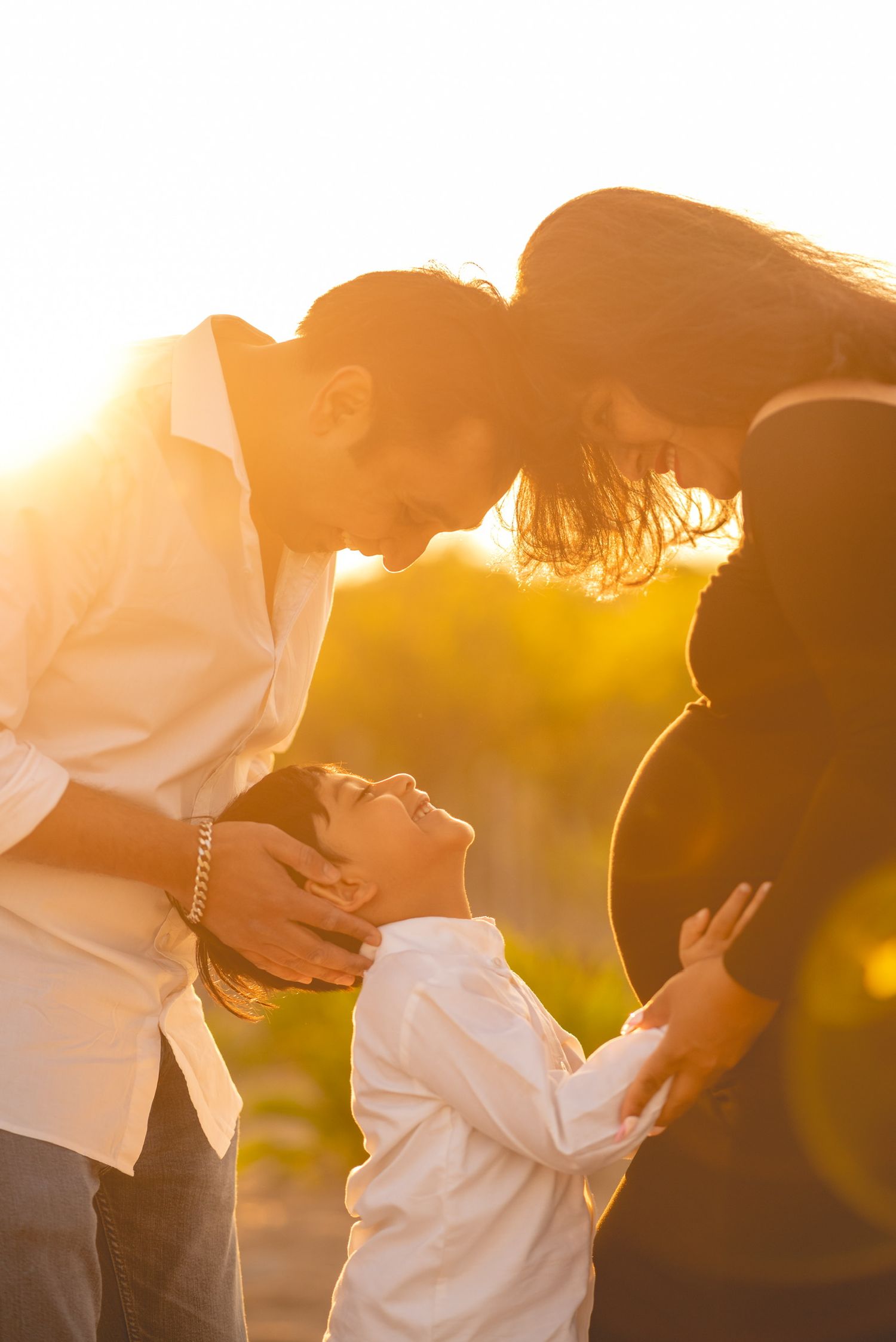 Intimate couple portraits in warm sunset lighting with artistic silhouettes.