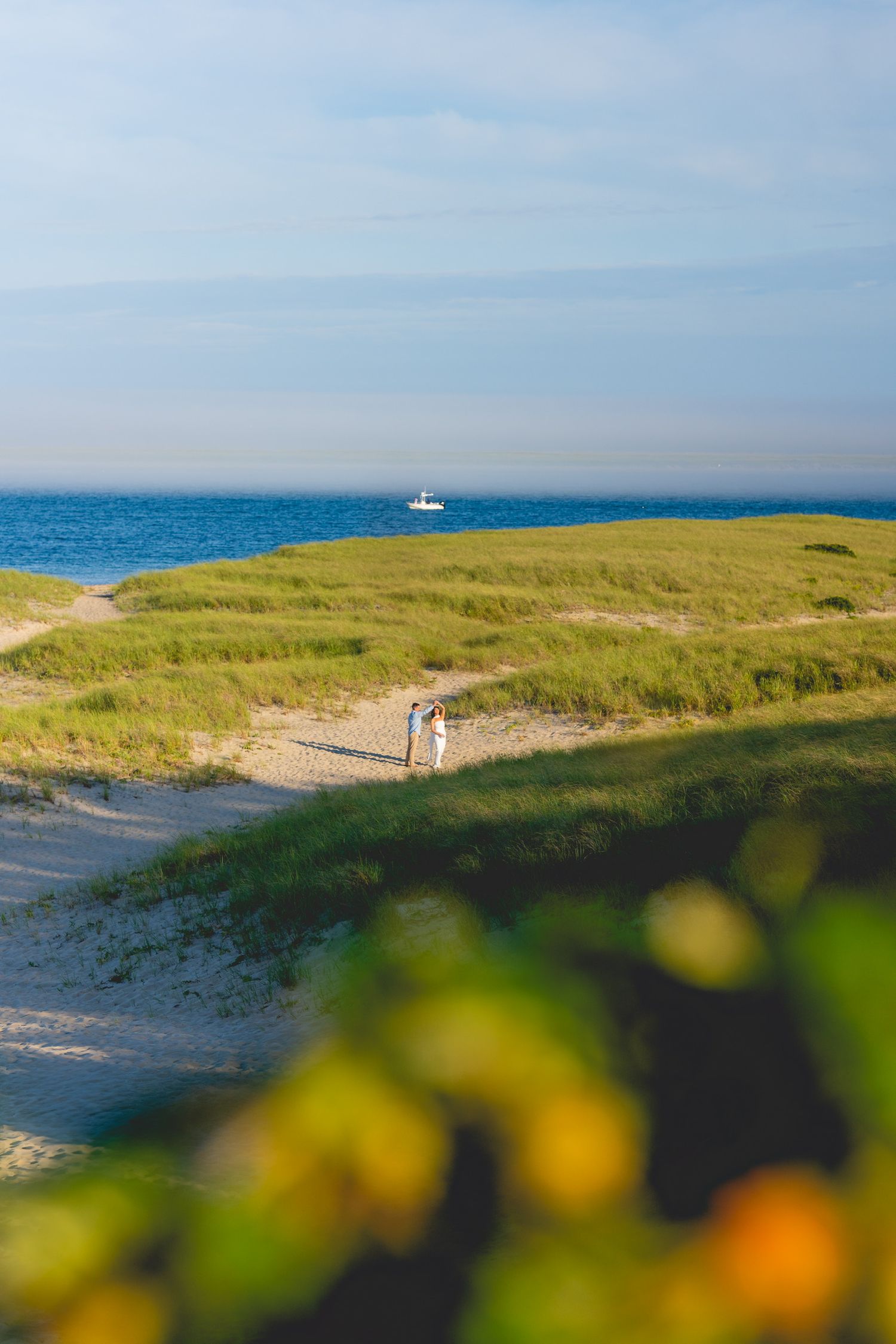 Coastal landscape  at Chatham Lighthouse Beach in Chatham, Massachusetts. with sand dunes, beach grass, and ocean view on a sunny day.