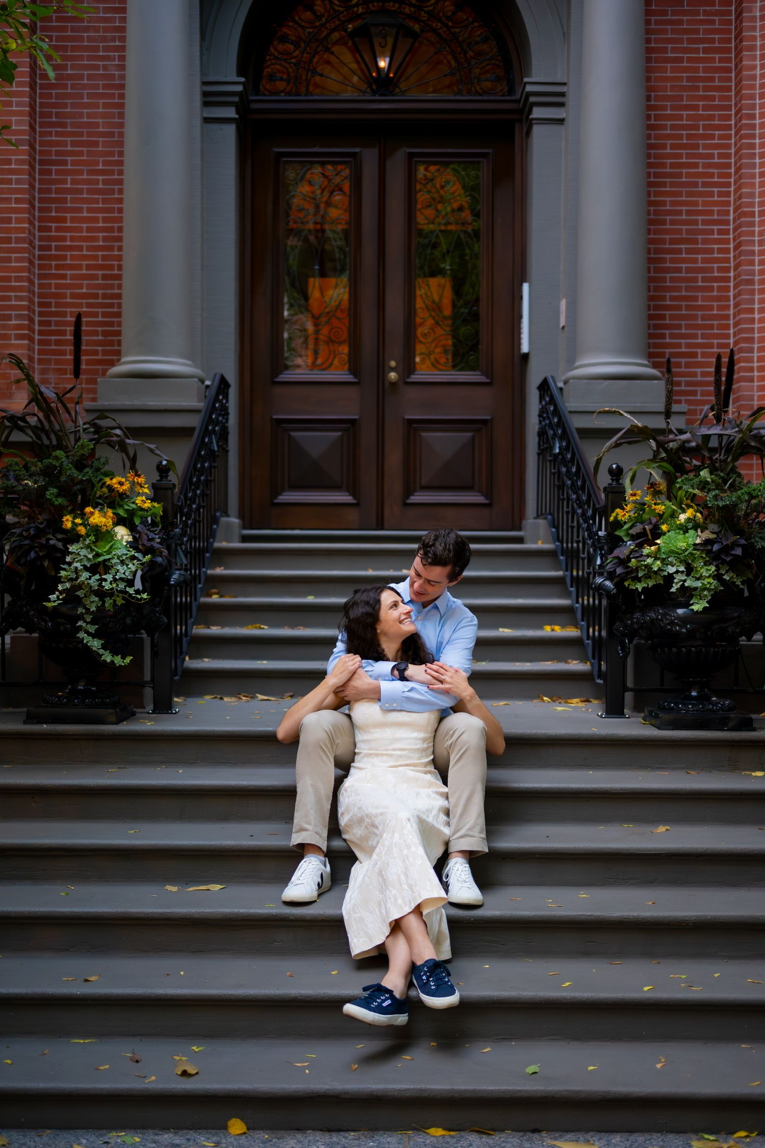 Romantic moment on steps in Boston, Massachusetts with autumn decorations.