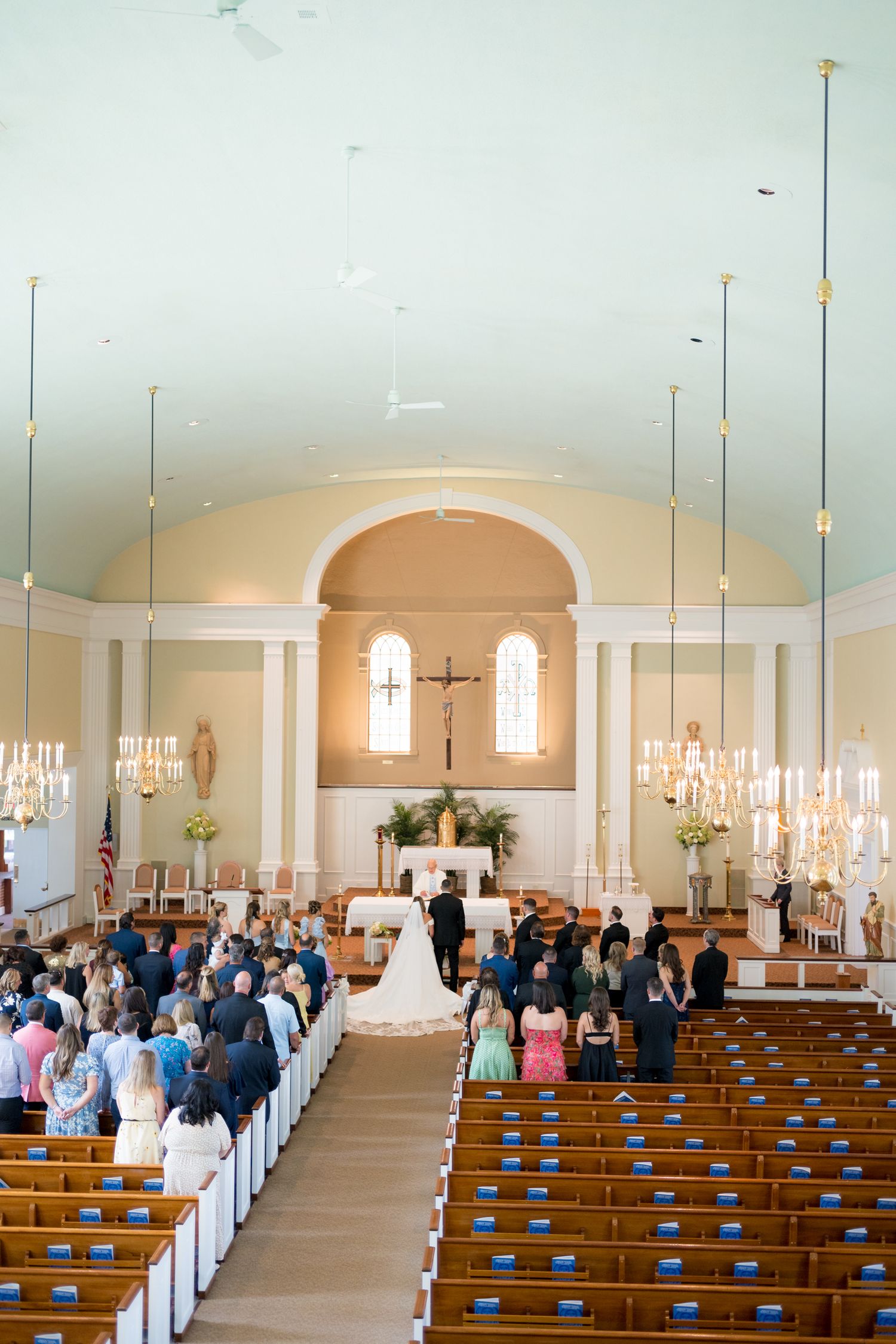 Spacious church sanctuary filled with guests during a wedding ceremony.