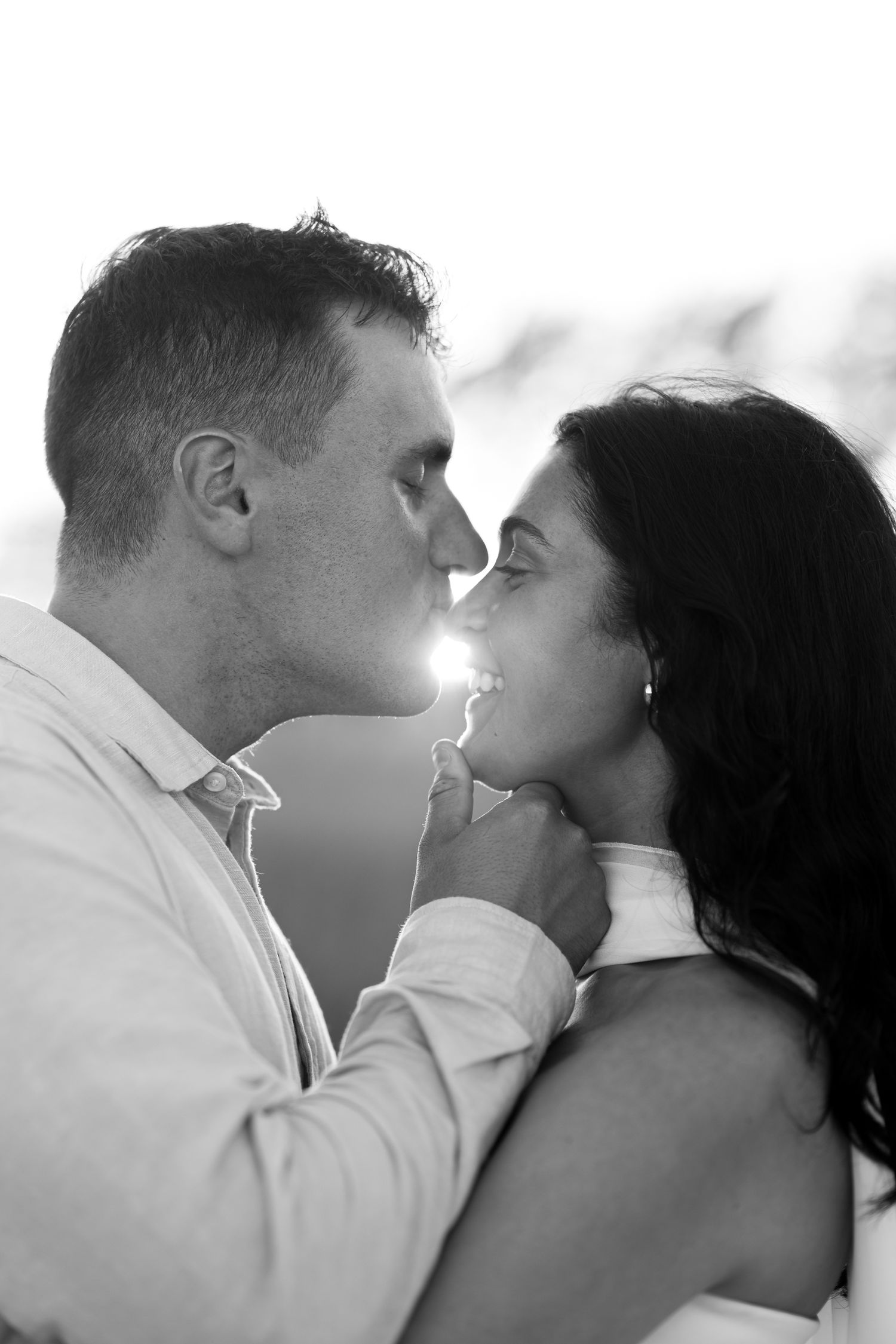 Intimate black and white portrait of couple sharing romantic moment in Cape Cod.