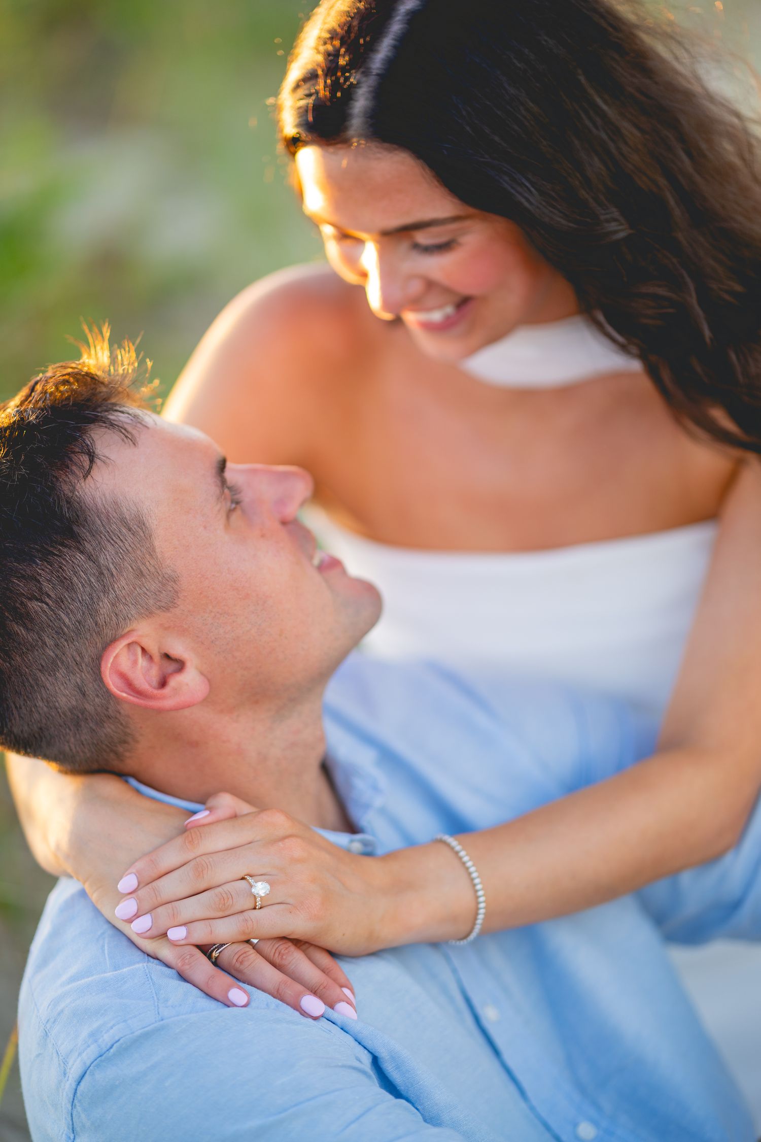 Intimate close-up shots showing couple's tender moments at Chatham Lighthouse Beach in Chatham, Massachusetts.