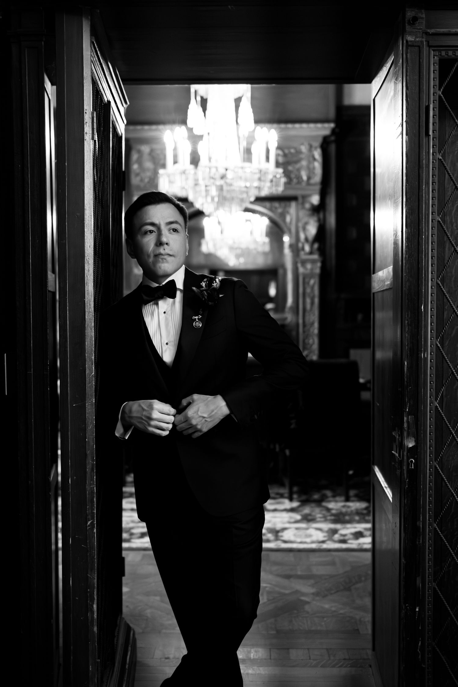 Dramatic black and white groom portraits in formal wear for castle wedding in New York.