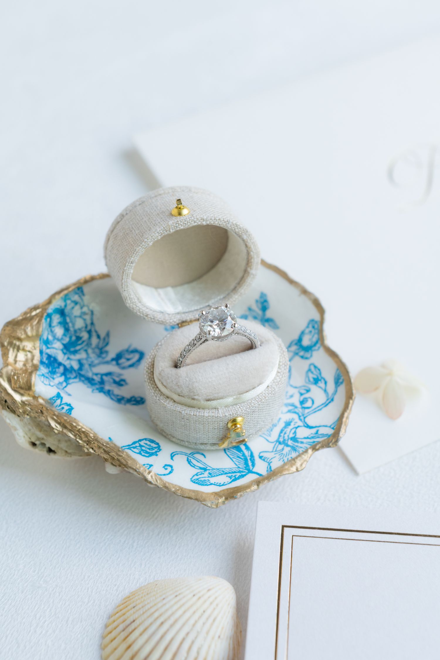 Decorative teacup with blue floral pattern and gold trim on white background.