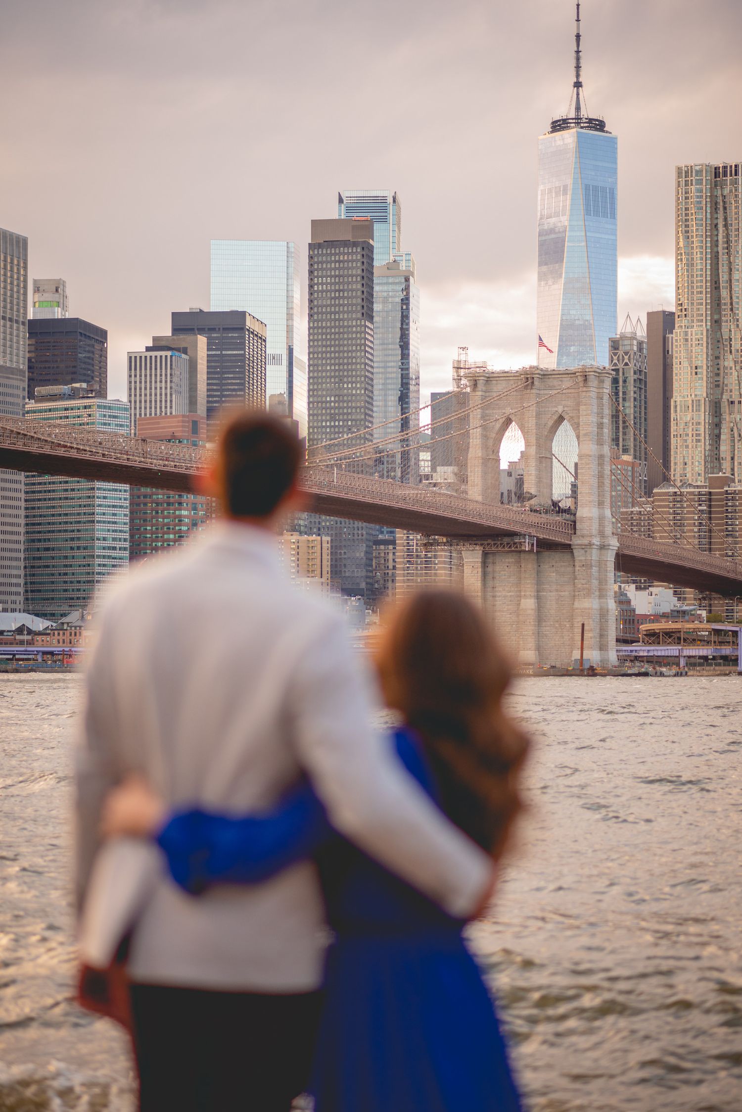 The Manhattan skyline and Brooklyn Bridge create a stunning backdrop over the East River.