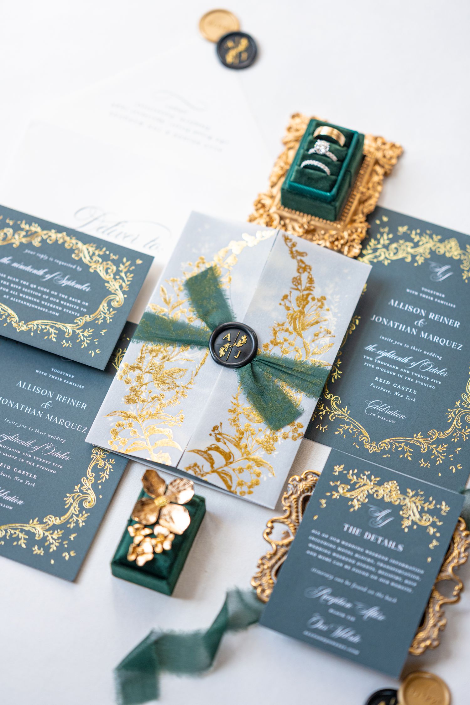 Luxury wedding invitation suite in navy blue and gold with velvet details and ornate flourishes.