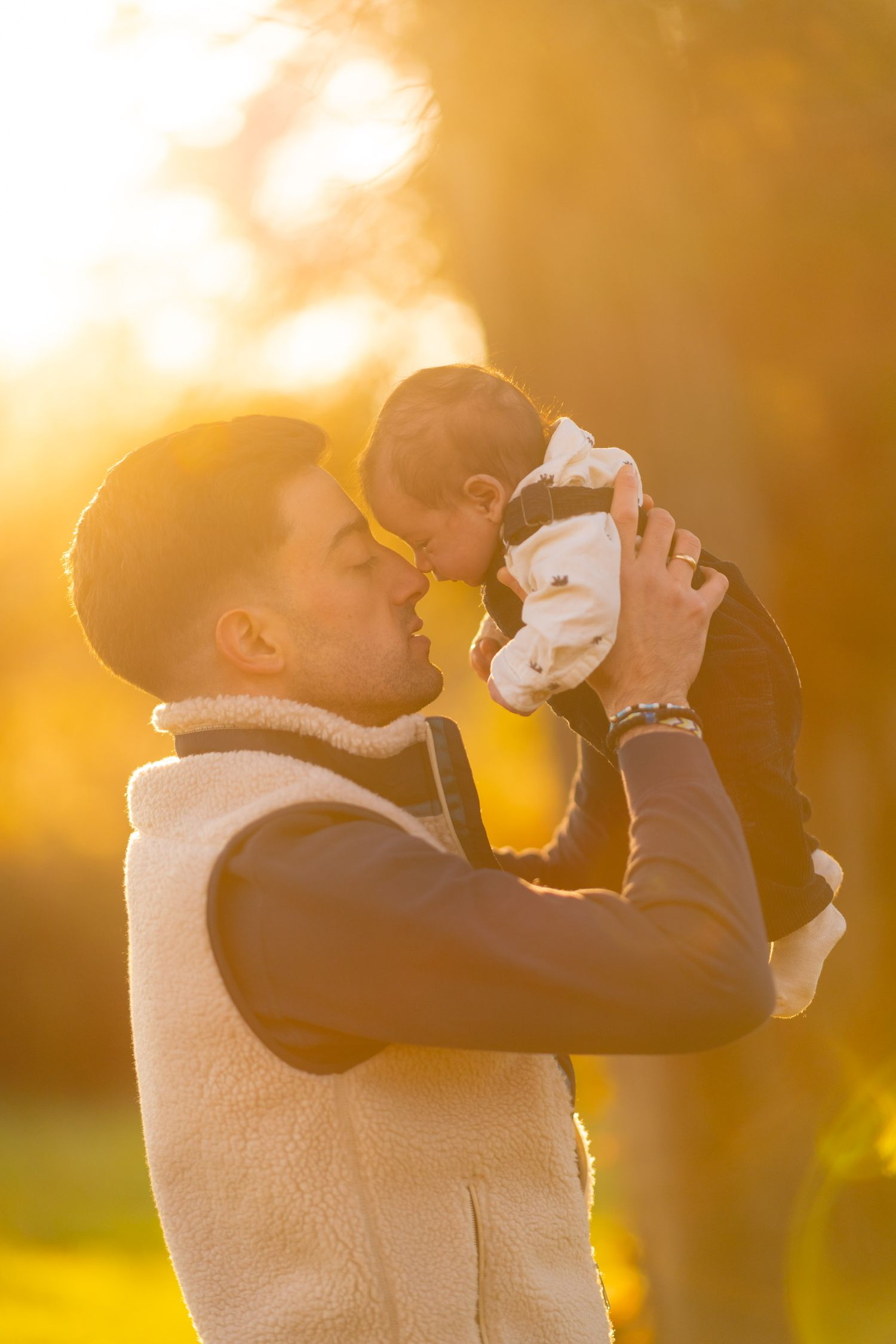 Parent and child sharing tender moments in golden sunset light.