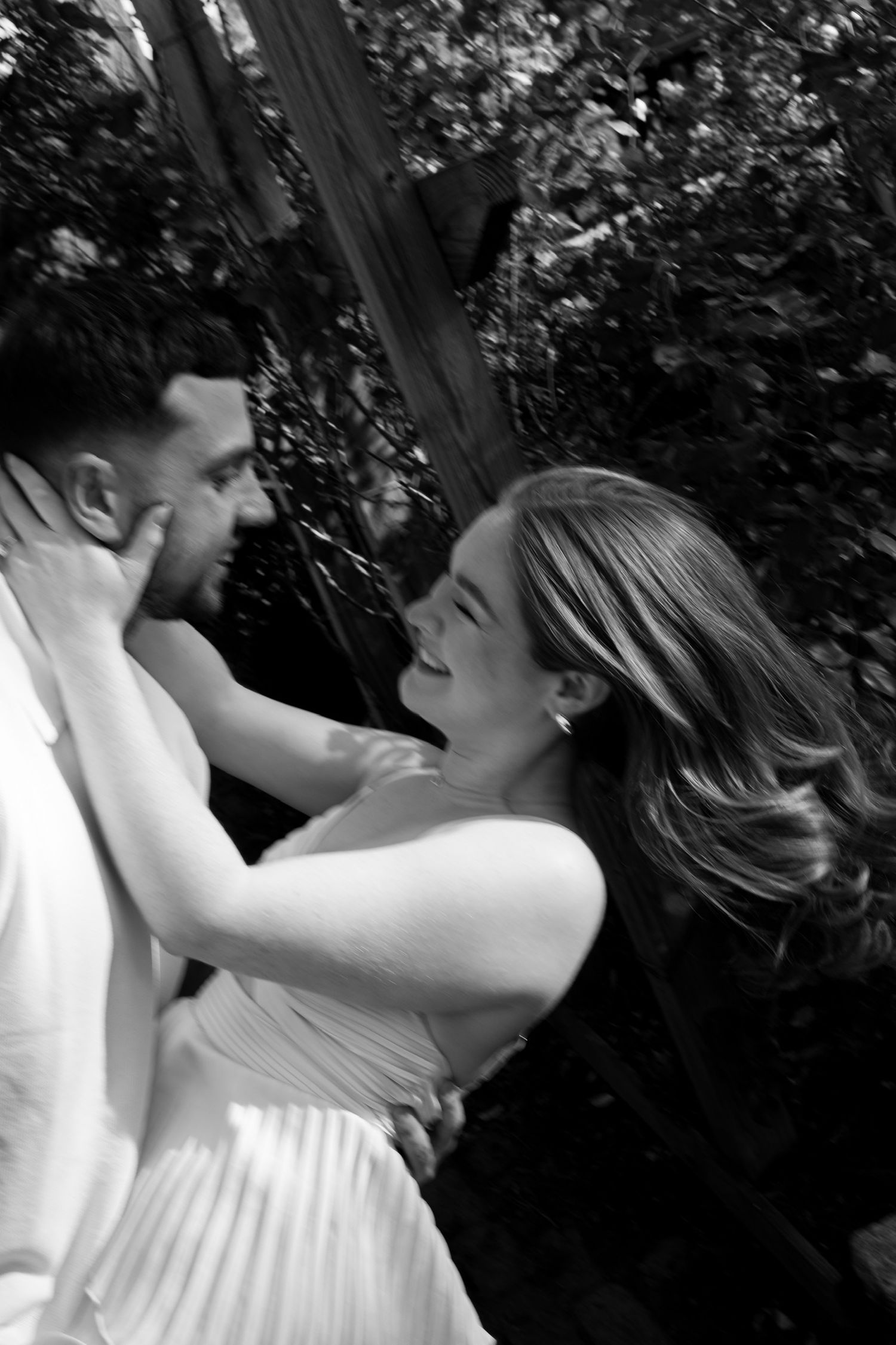 Black and white romantic sequence of couple embracing in natural setting.