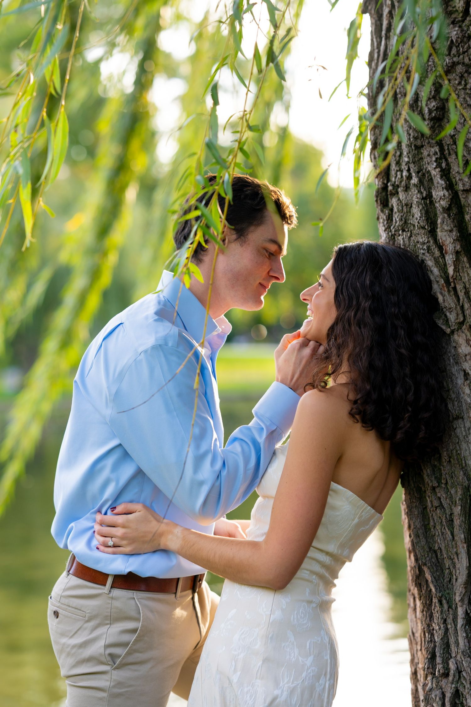 A romantic outdoor wedding photo sequence showing a couple embracing near a willow tree in natural lighting in Boston, Massachusetts.