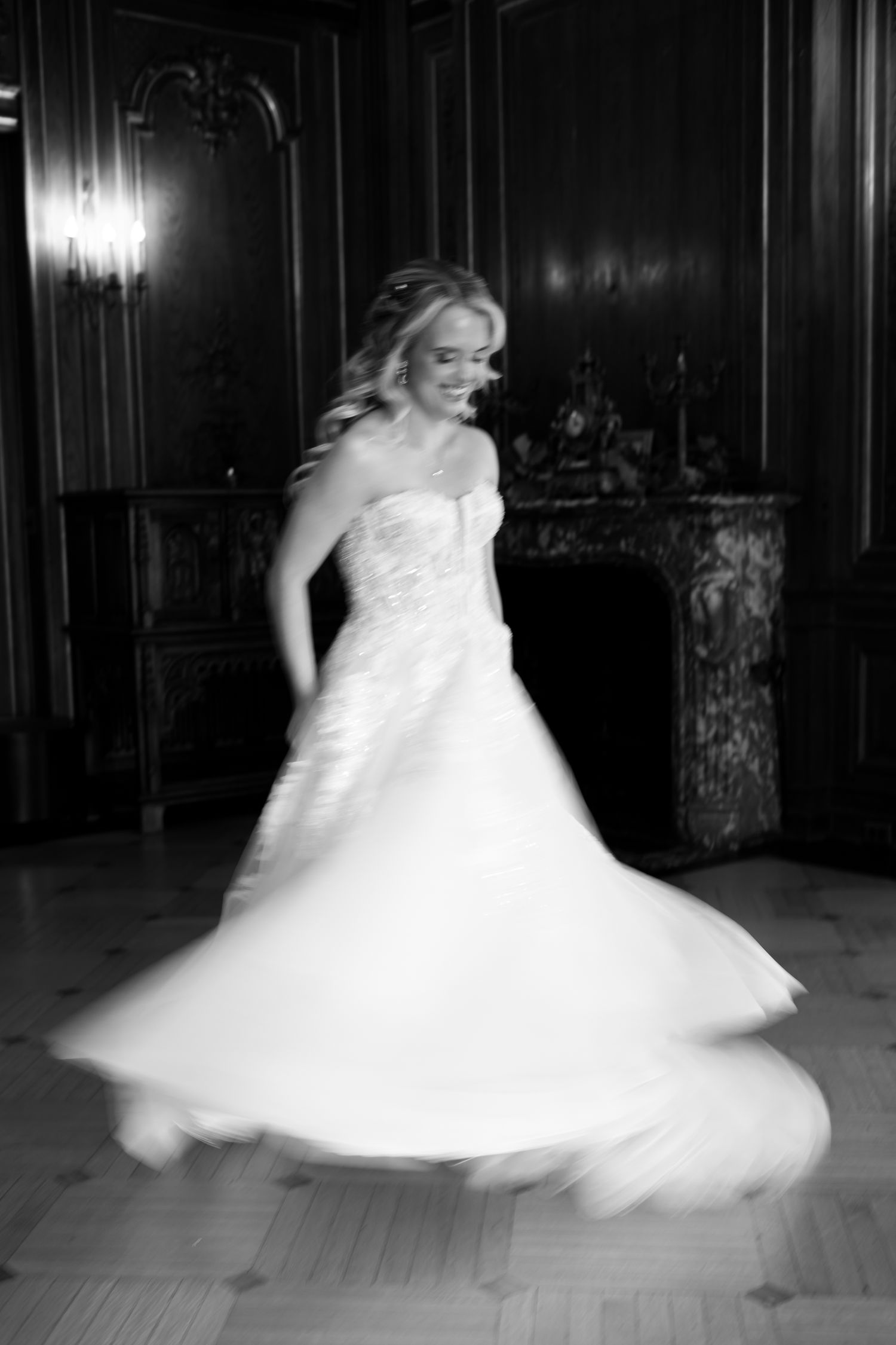 A series of black and white photos showing a bride in a flowing white gown twirling and dancing in an elegant ballroom.