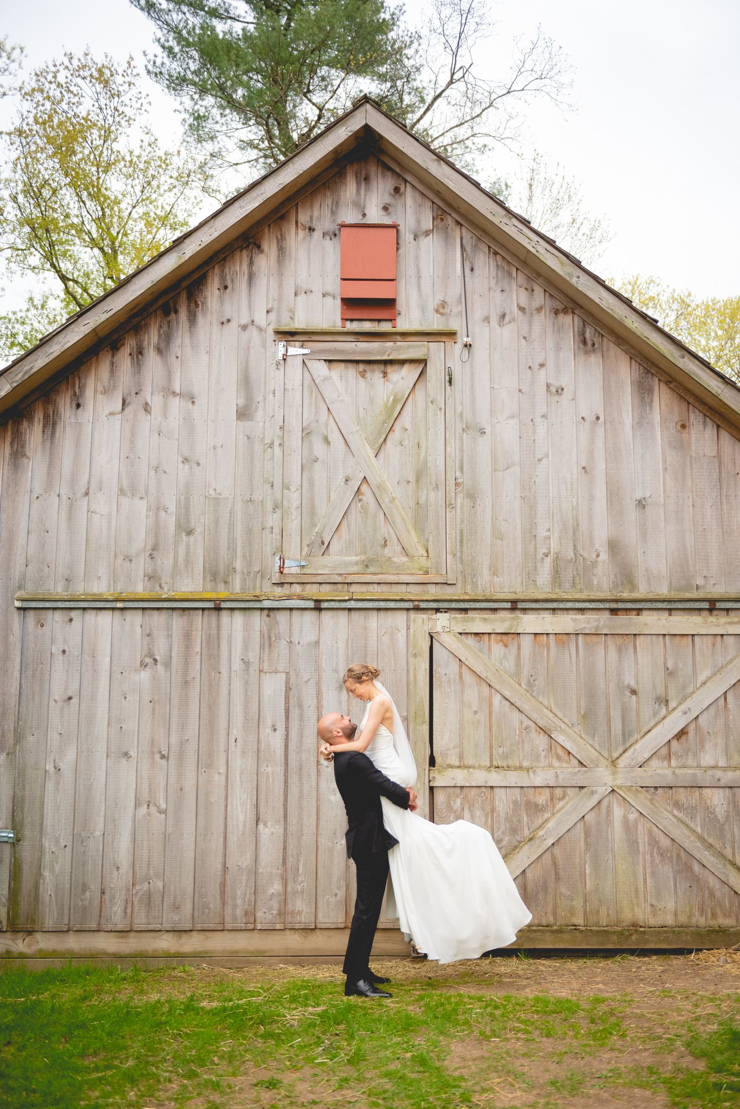 Artistic wedding photo sequence against rustic wooden barn backdrop.