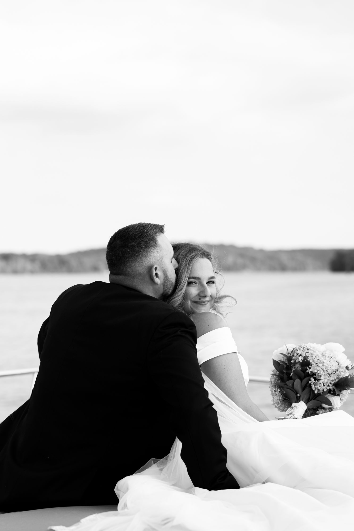 Black and white wedding photo sequence showing tender moments between newlyweds lying down together.