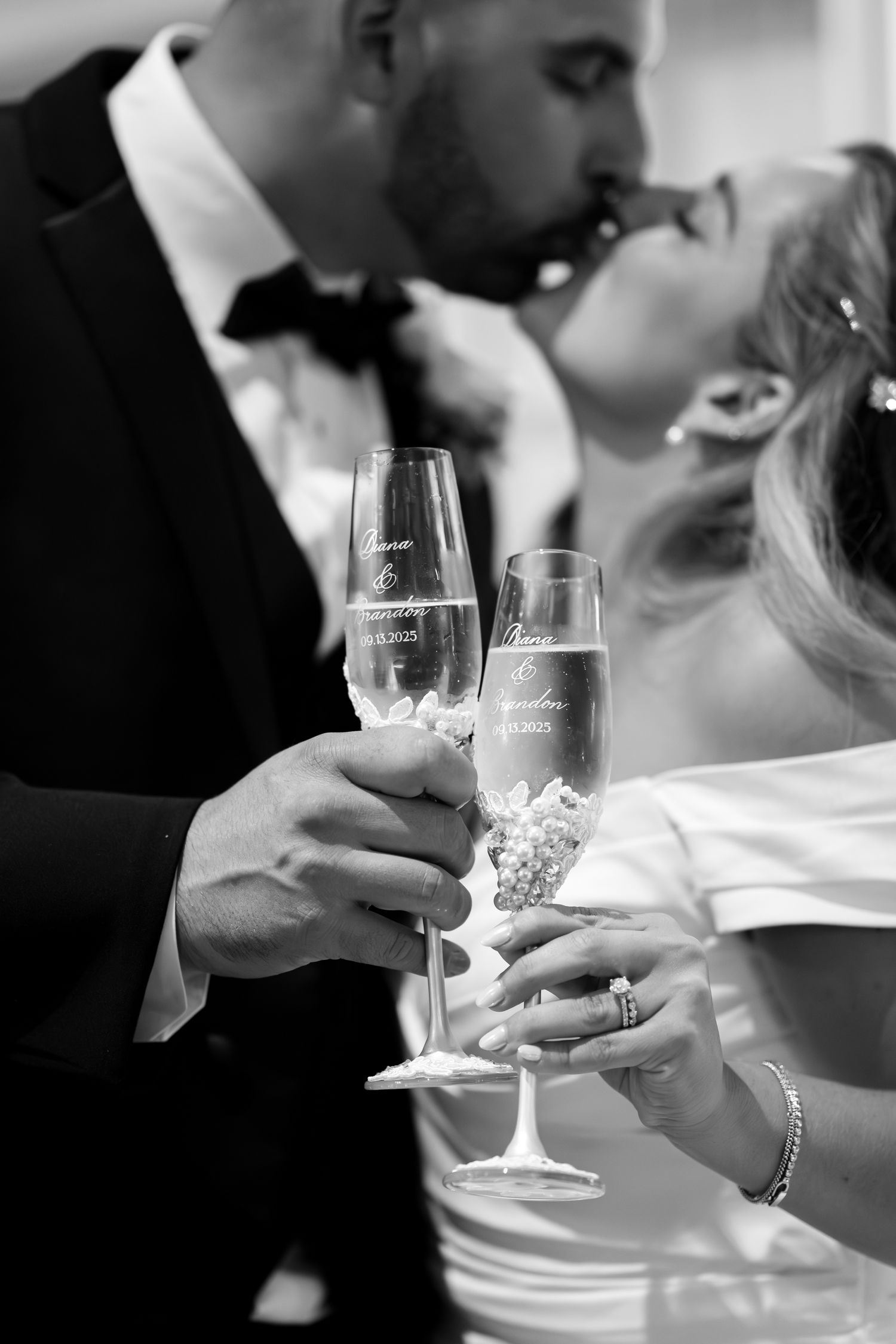 Close-up of champagne glasses being held during a wedding toast.