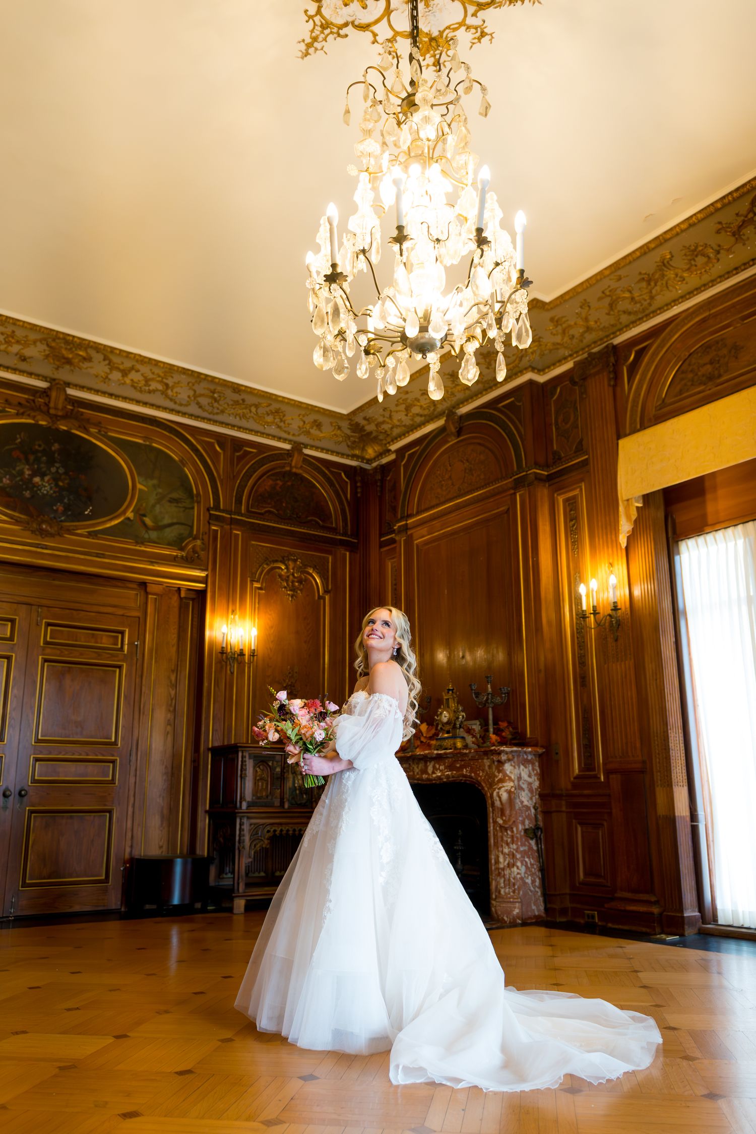 A flowing white wedding dress twirls elegantly in a grand ballroom with crystal chandeliers and ornate wood-paneled walls.