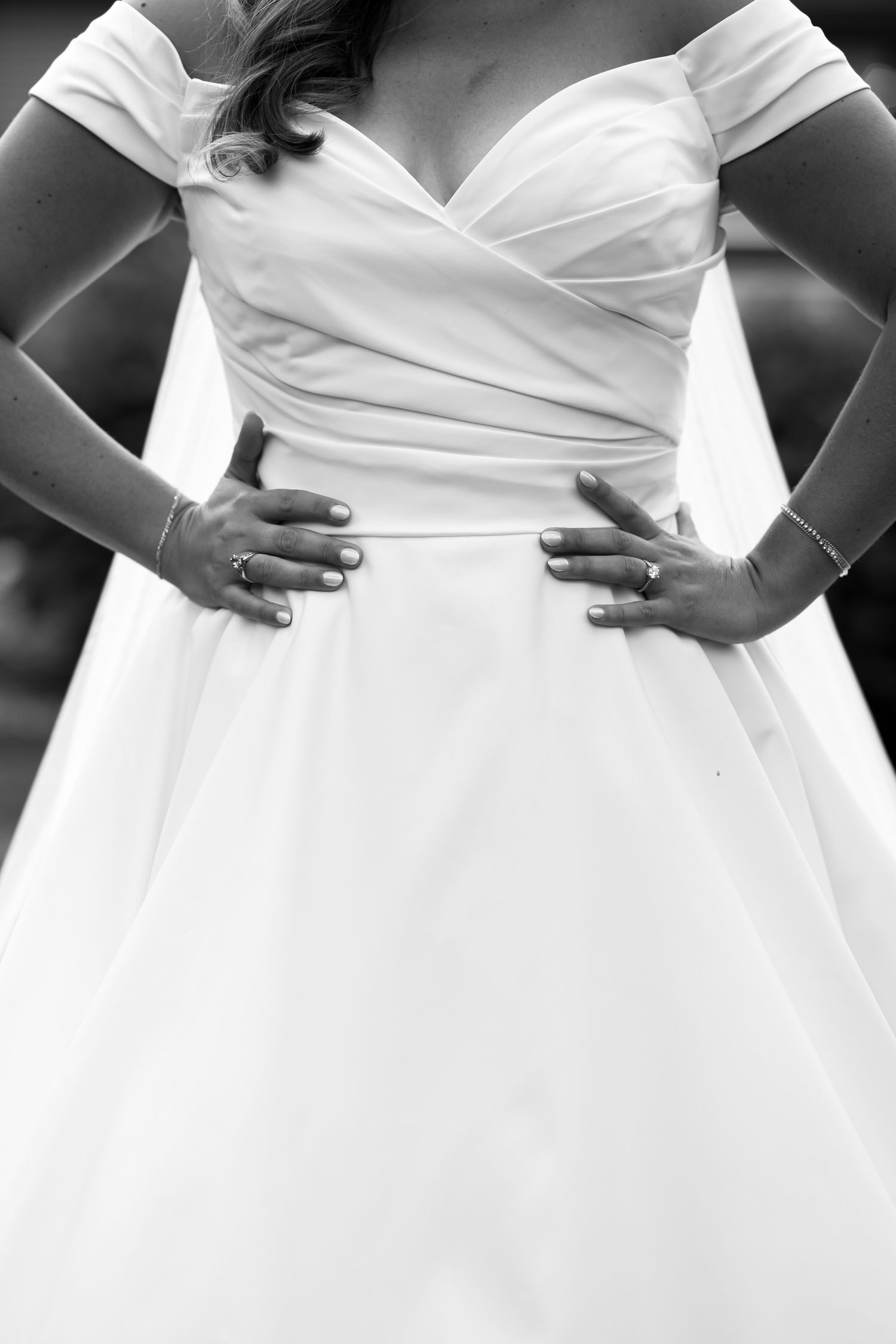 Close-up details of a white wedding dress bodice with pleated fabric design.