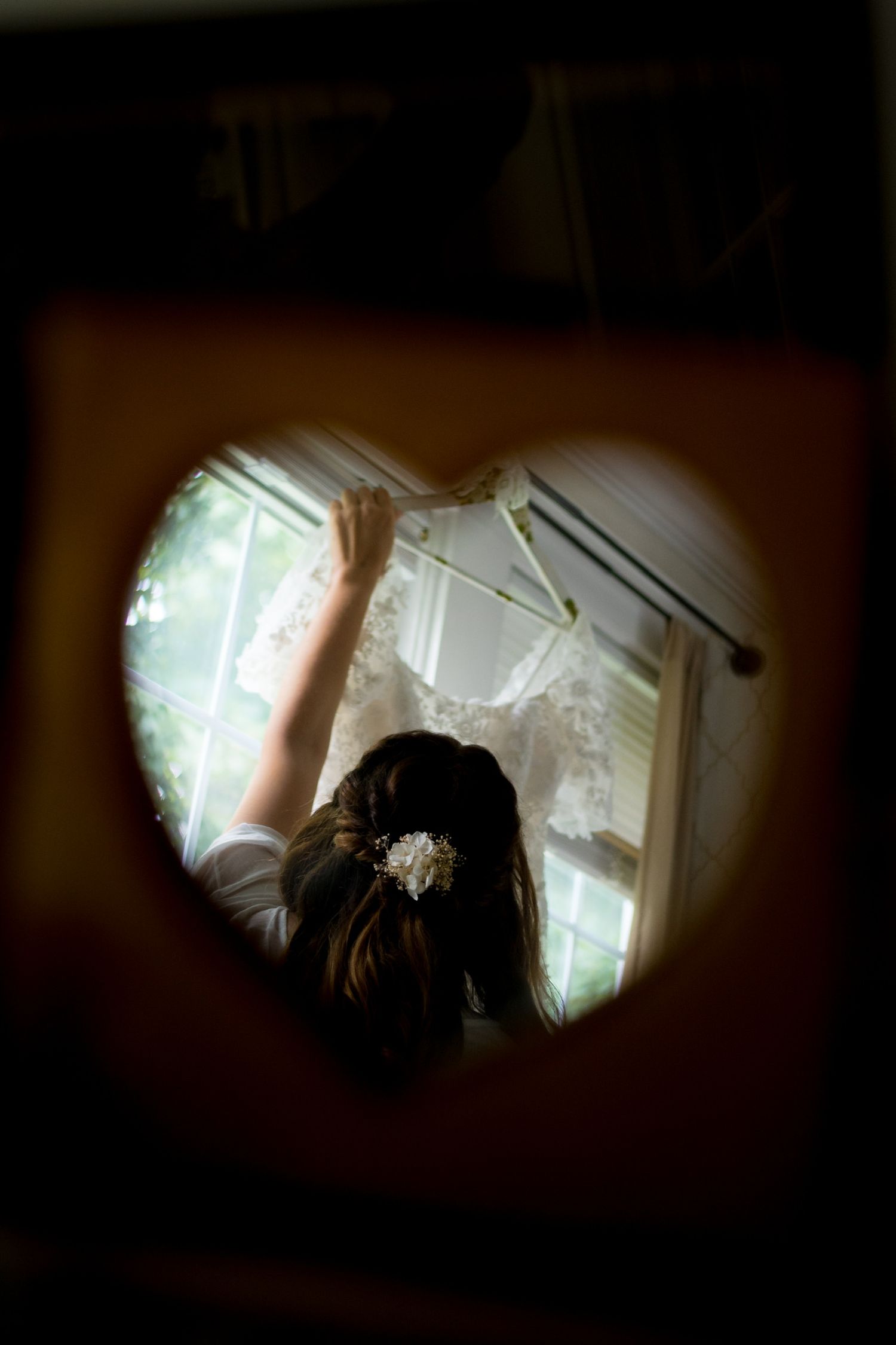 Artistic wedding photo taken through keyhole with soft natural lighting.