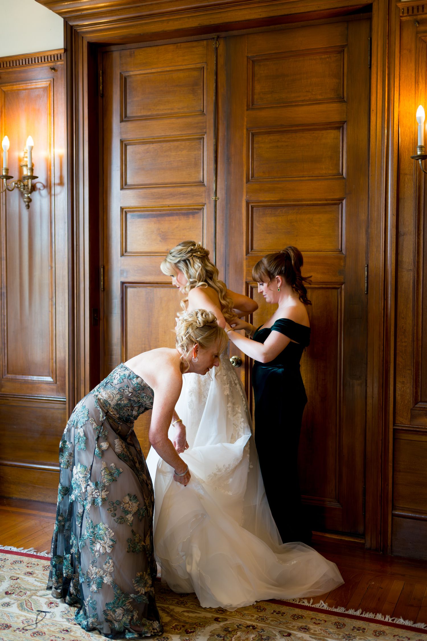 Three sequential photos show a wedding dress being adjusted and arranged on a wooden-paneled floor.