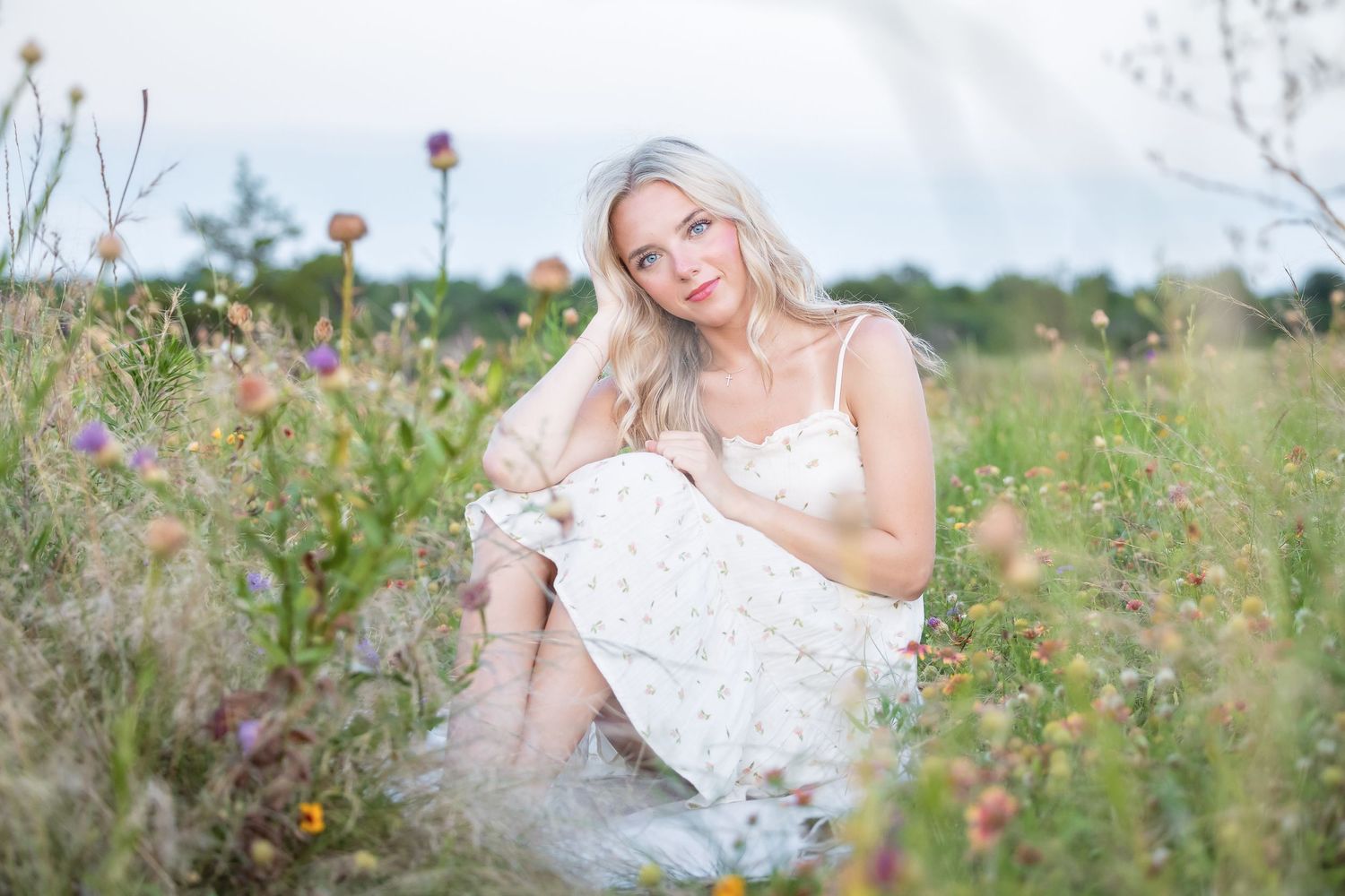 Outdoor portrait session in a wildflower field during golden hour.
