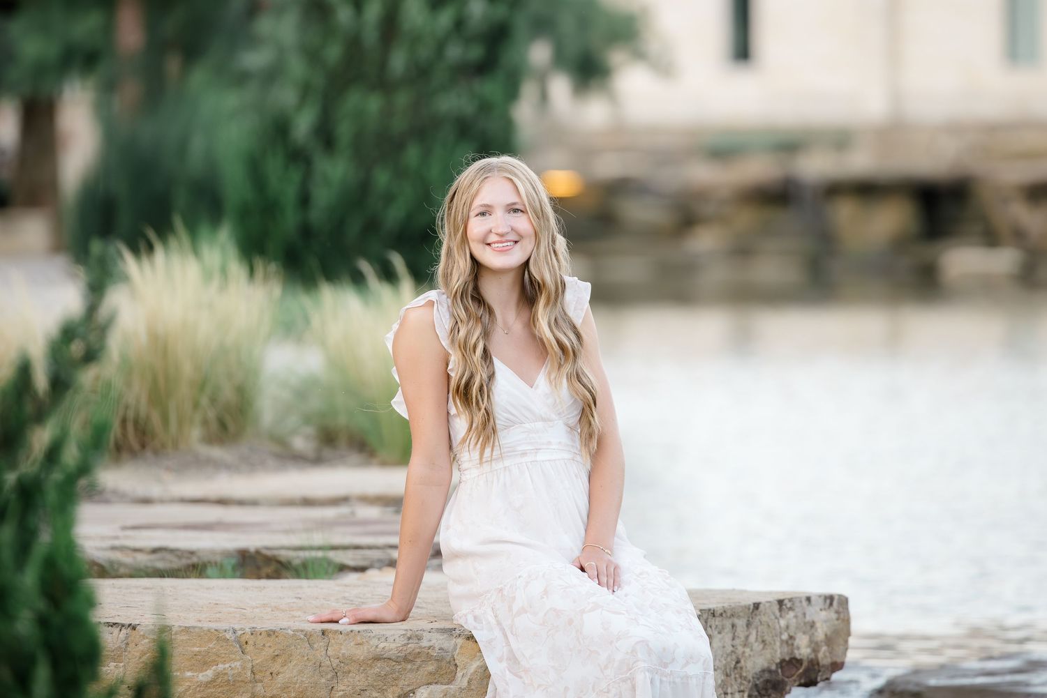 Outdoor portrait session near a waterfront with stone features.