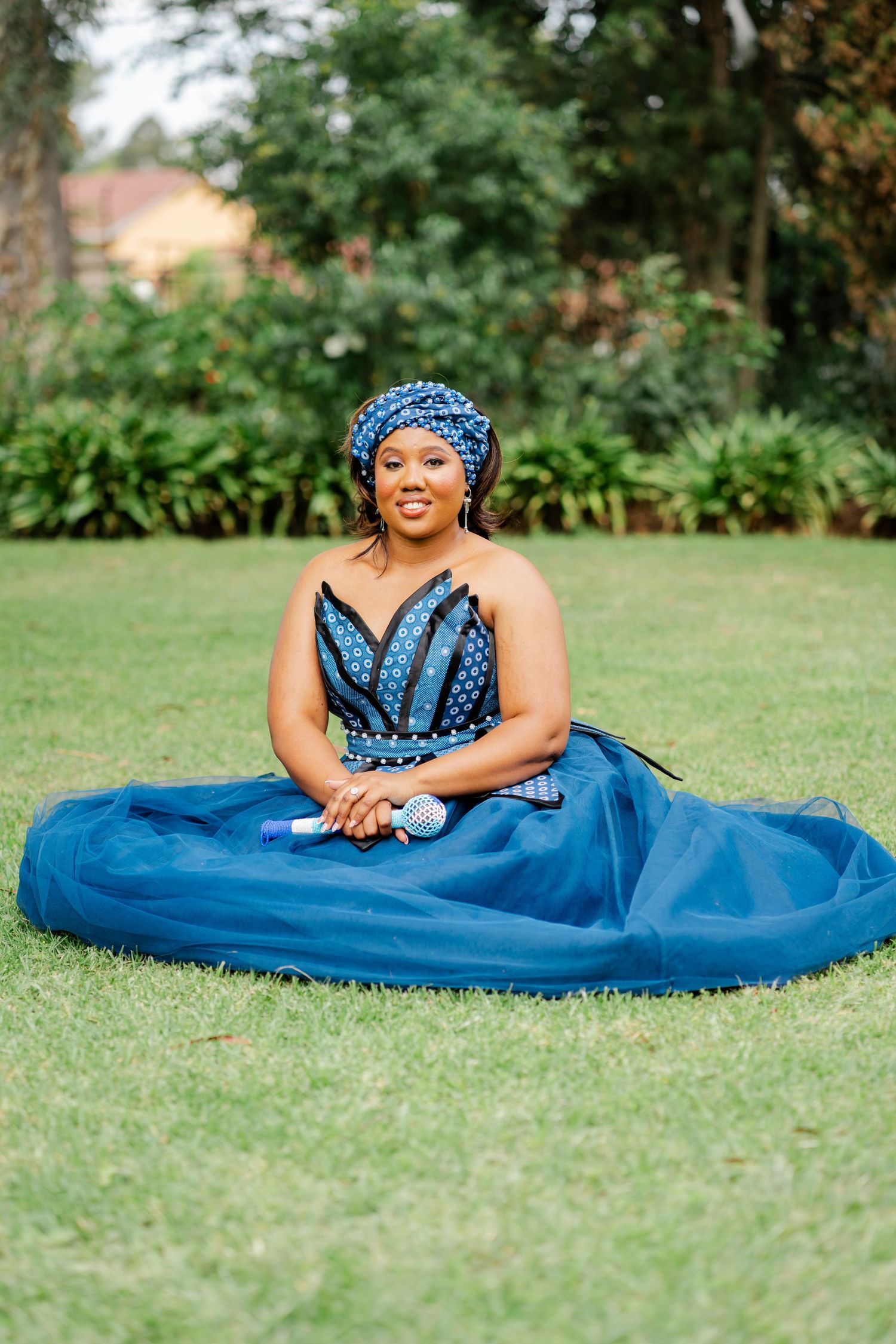 Bride in a blue traditional wedding dress seated on the lawn at a Gauteng wedding venue
