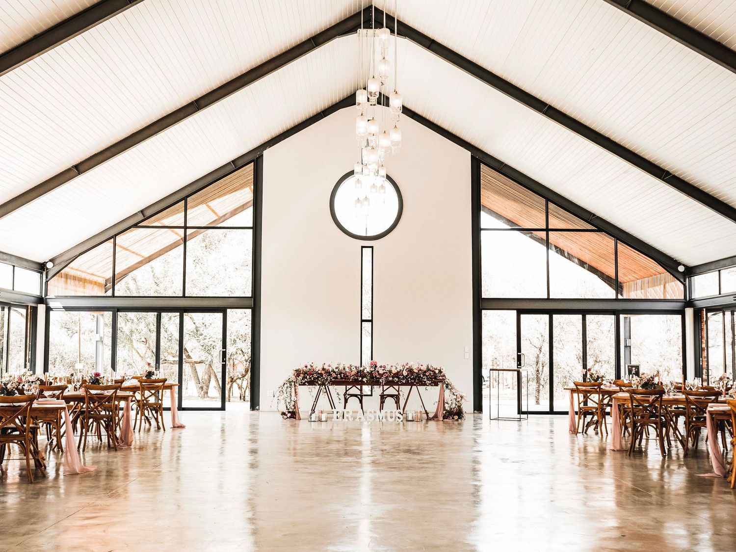 Empty wedding reception hall with round pendant light and timber ceiling