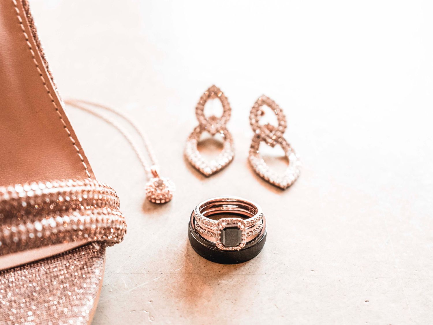 Bridal accessories flat lay with earrings, clutch bag and perfume