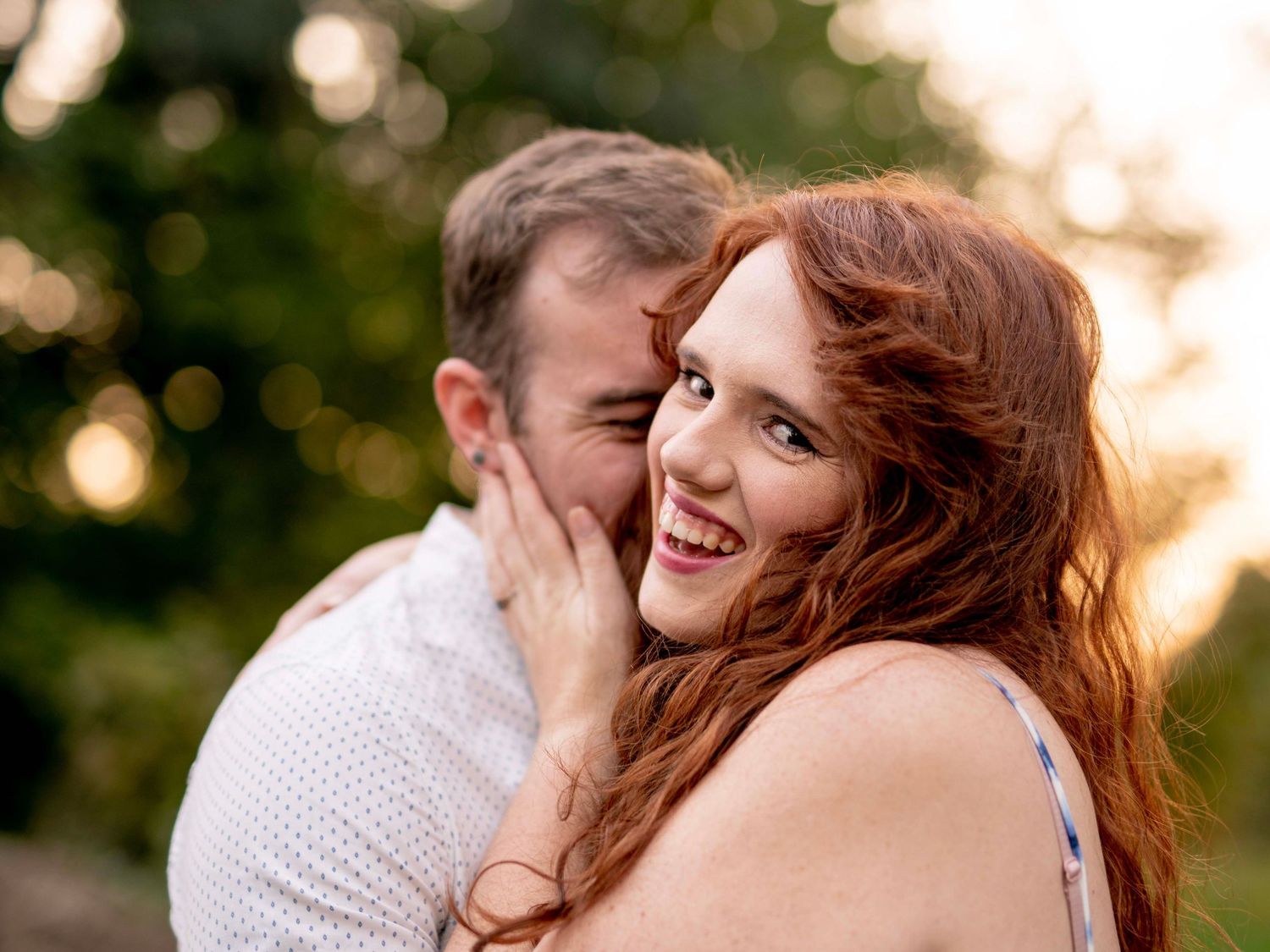 Couple laughing together outdoors during their engagement mini session