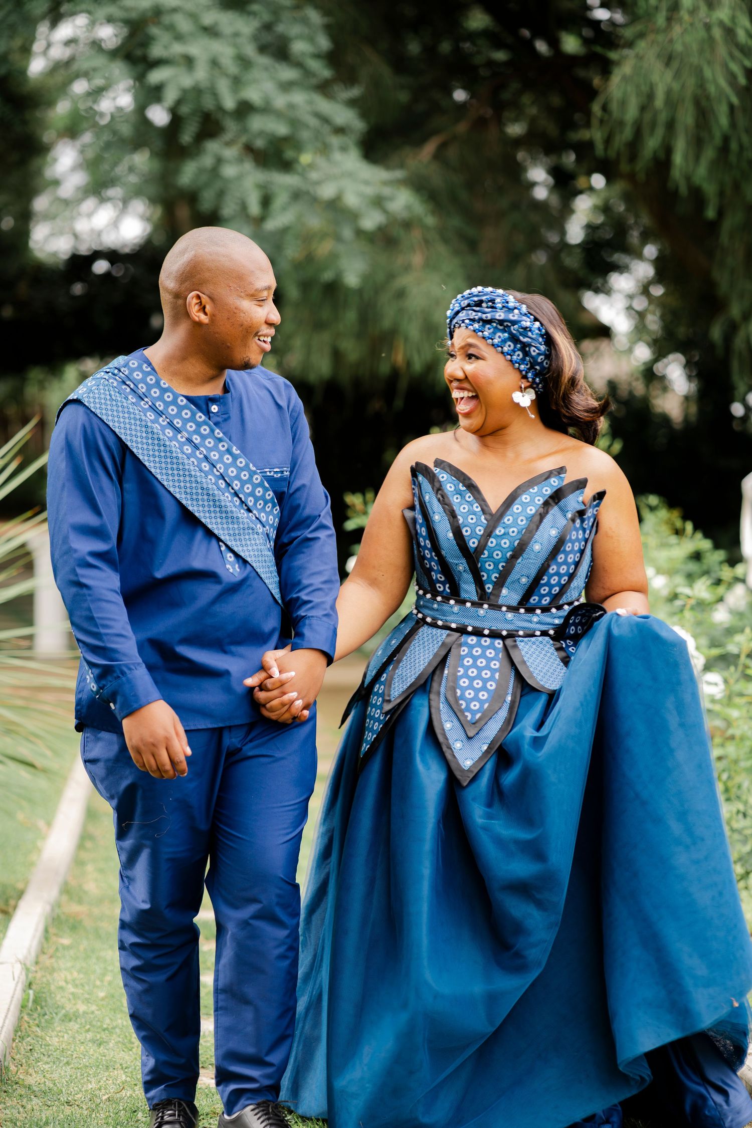 Bride and groom walking hand in hand through a garden at their Gauteng wedding