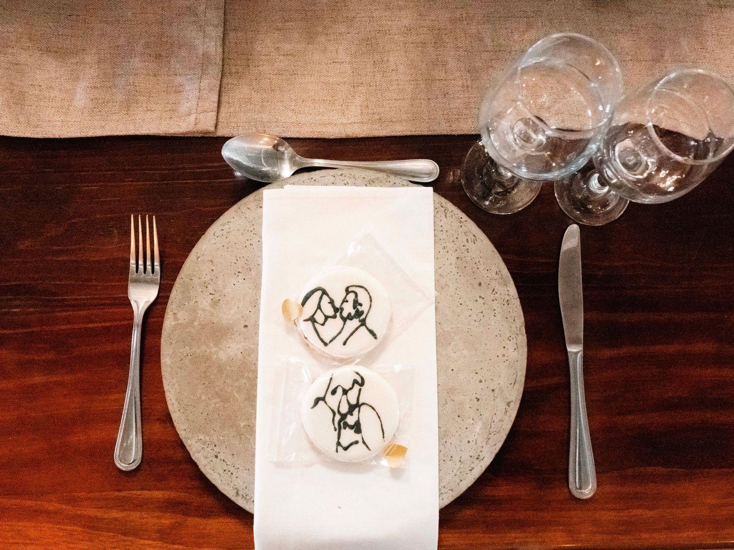Wedding table place setting with a monogrammed napkin and glassware