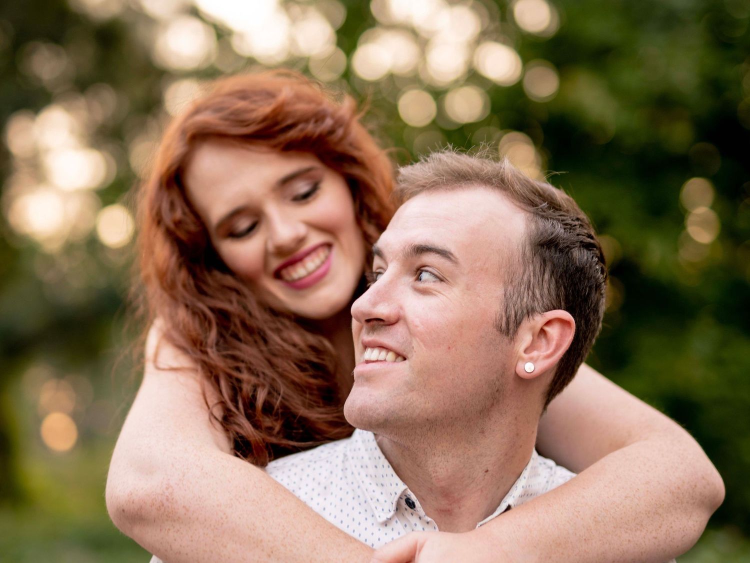 Couple laughing nose to nose during their outdoor engagement photo session