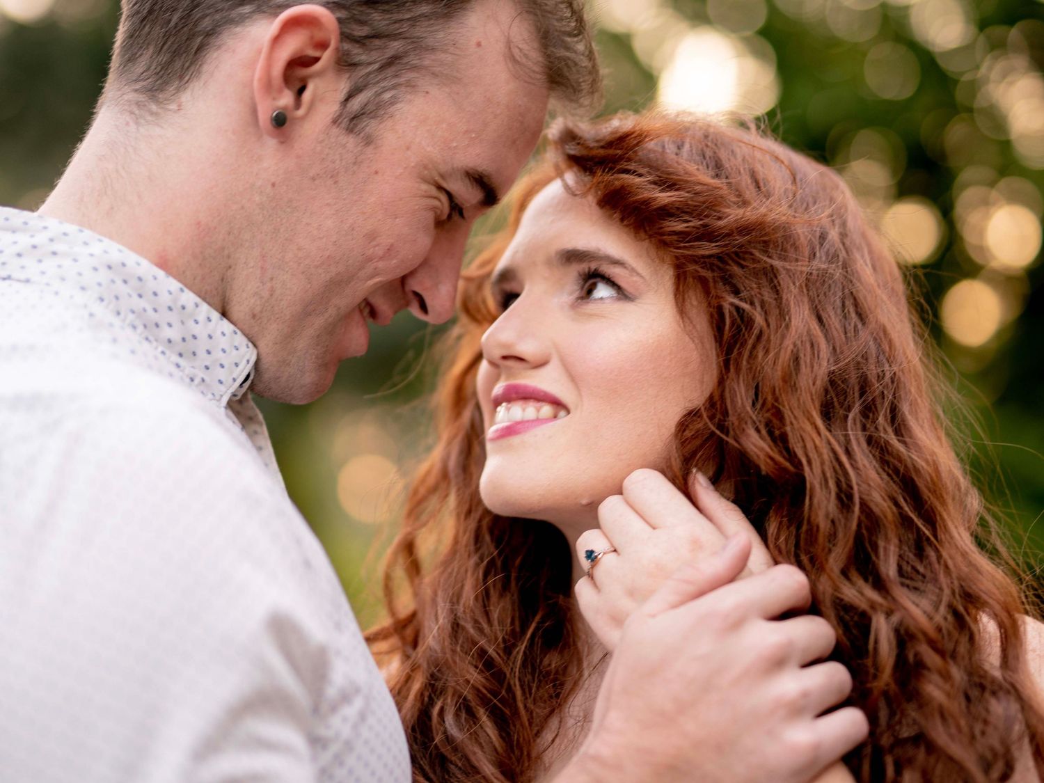 Couple with foreheads together sharing an intimate engagement session moment