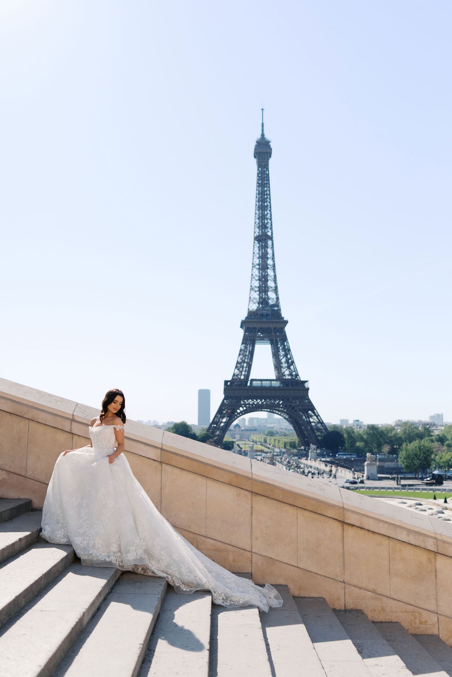 A beautiful bridal portrait session showcasing a flowing white gown against the majestic Eiffel Tower in Paris.