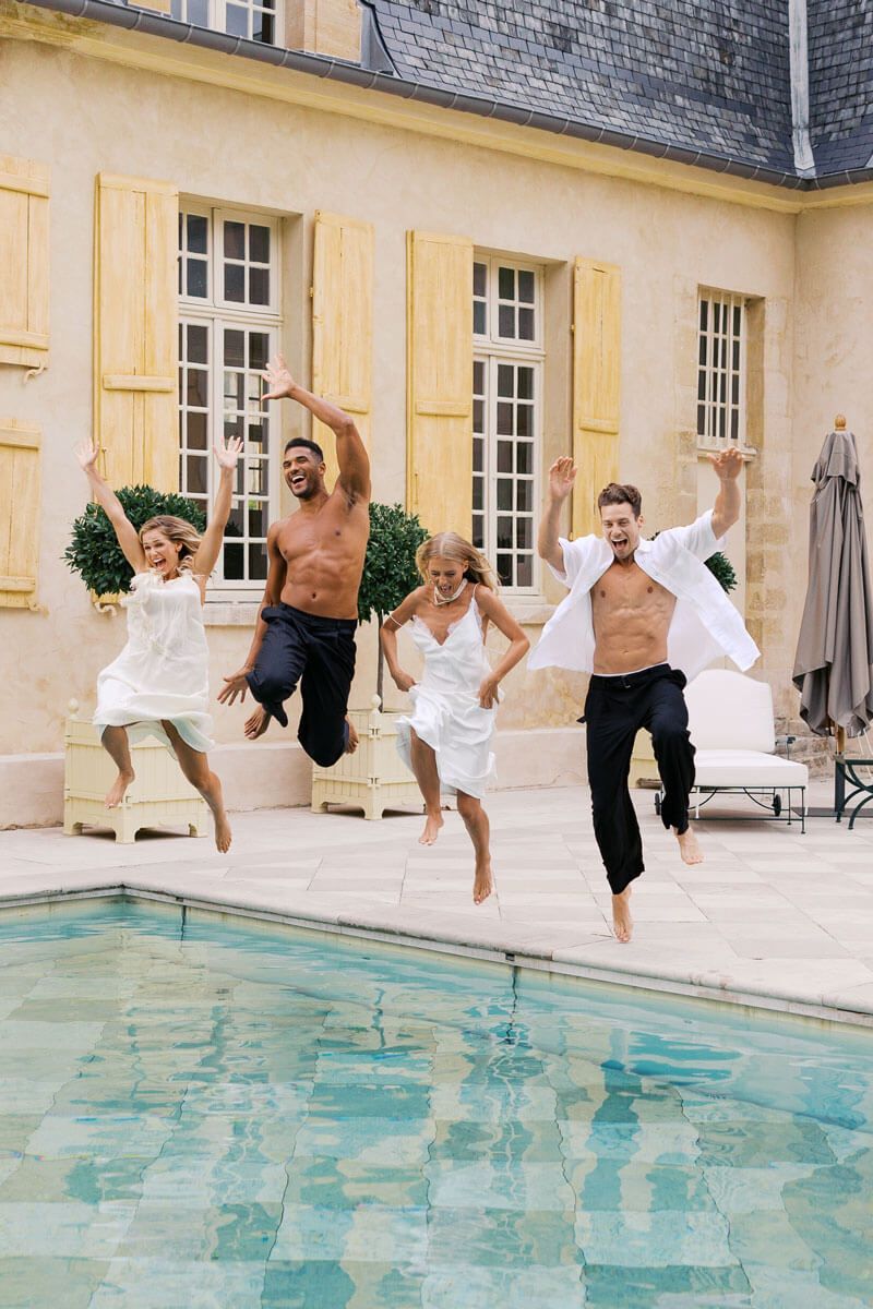 Sequential photos capturing people jumping into a swimming pool at an elegant mansion with French windows.