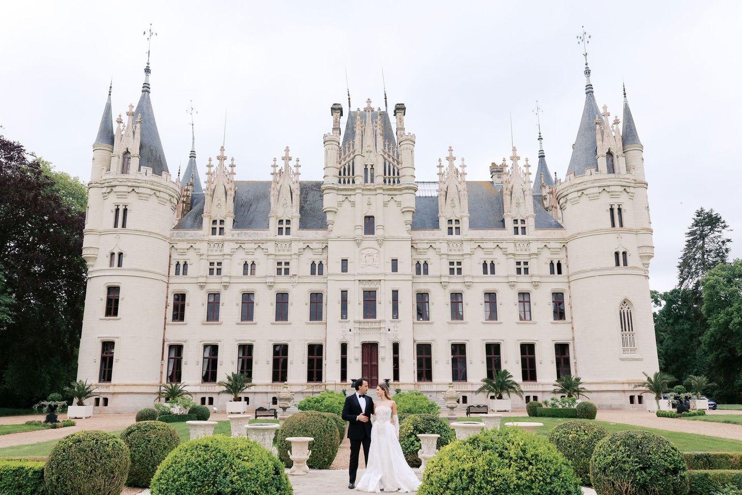 Majestic white French chateau with multiple towers and spires shown from different angles in a photo collage.