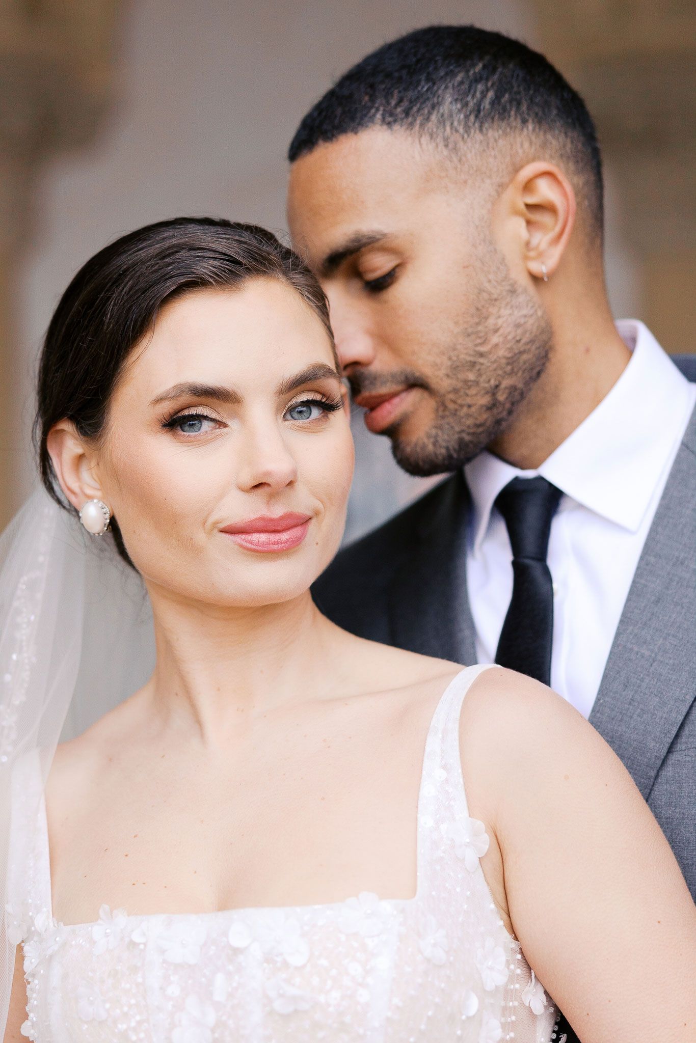 A romantic wedding photo series showing tender moments between a bride in white lace and groom in grey suit.
