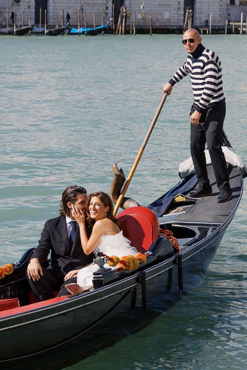 Couple enjoying a romantic gondola ride through Venice's historic canals.
