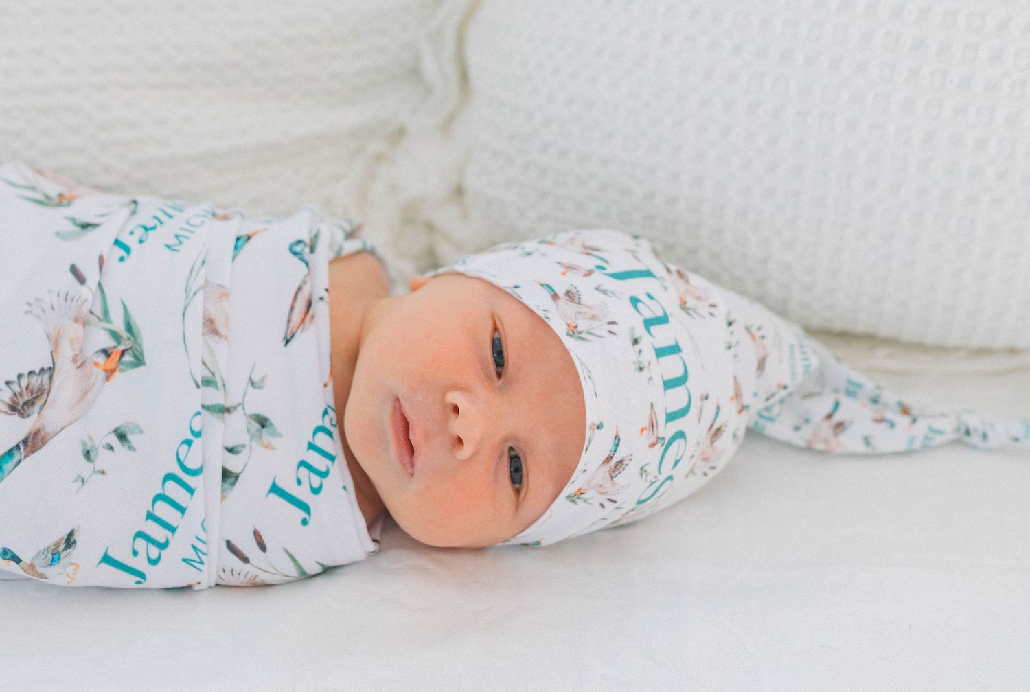 newborn baby swaddled in natural light.
