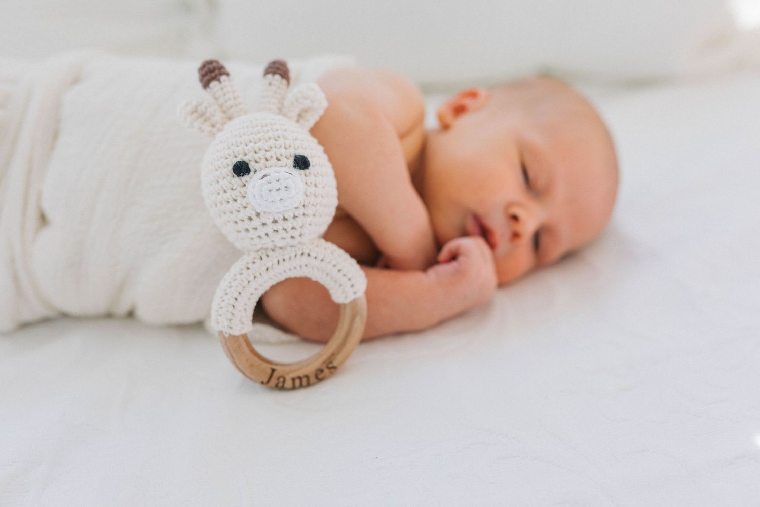 newborn baby with toy. natural light. natural posing