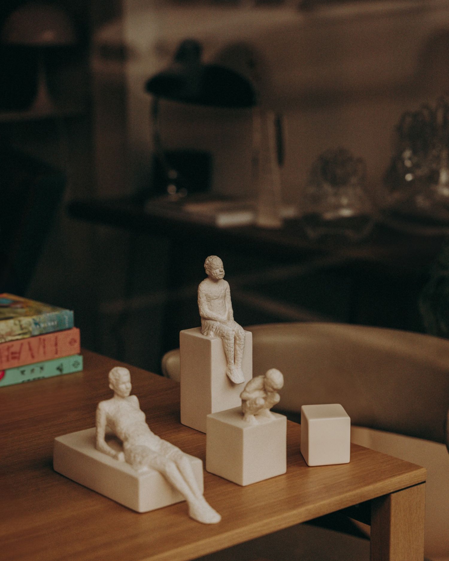 Minimal ceramic sculptures on a wood tabletop in moody light — interior detail photography by Sigi in Dublin.