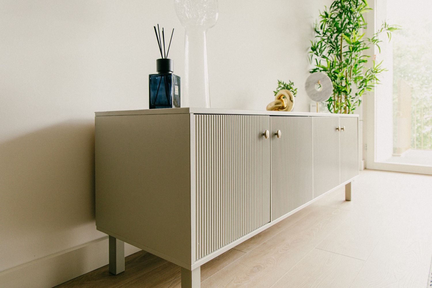 Interior detail of a console styled with modern decor, green foliage, and soft daylight — perfect for design-focused visuals, minimal style.