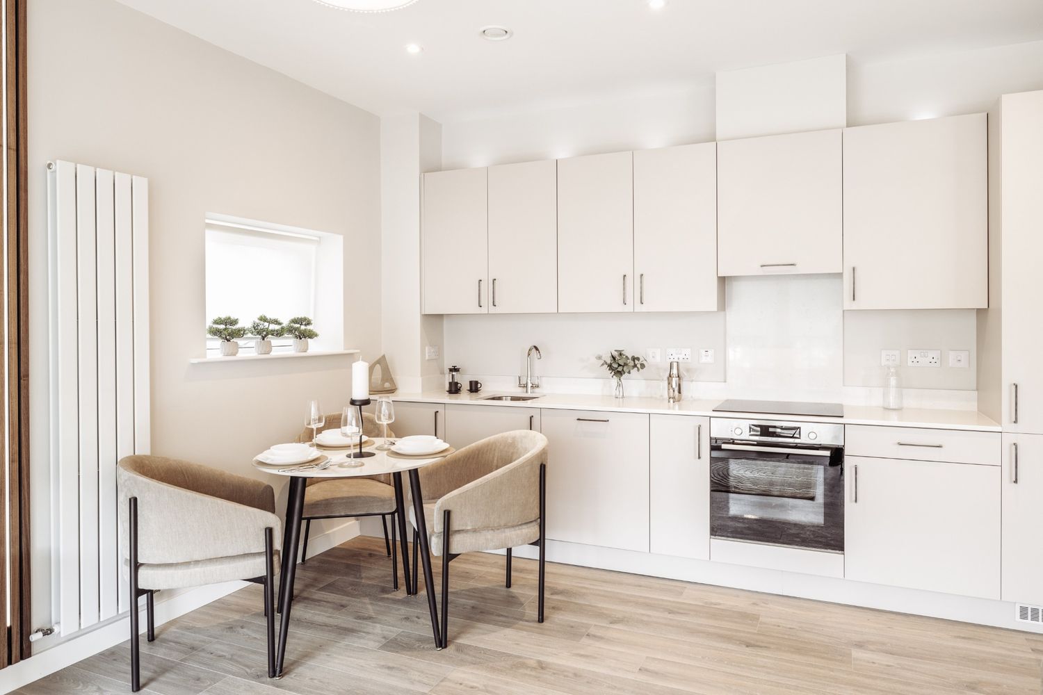 Bright Dublin kitchen with light cabinetry, round dining table, and clean minimalist styling in natural light.