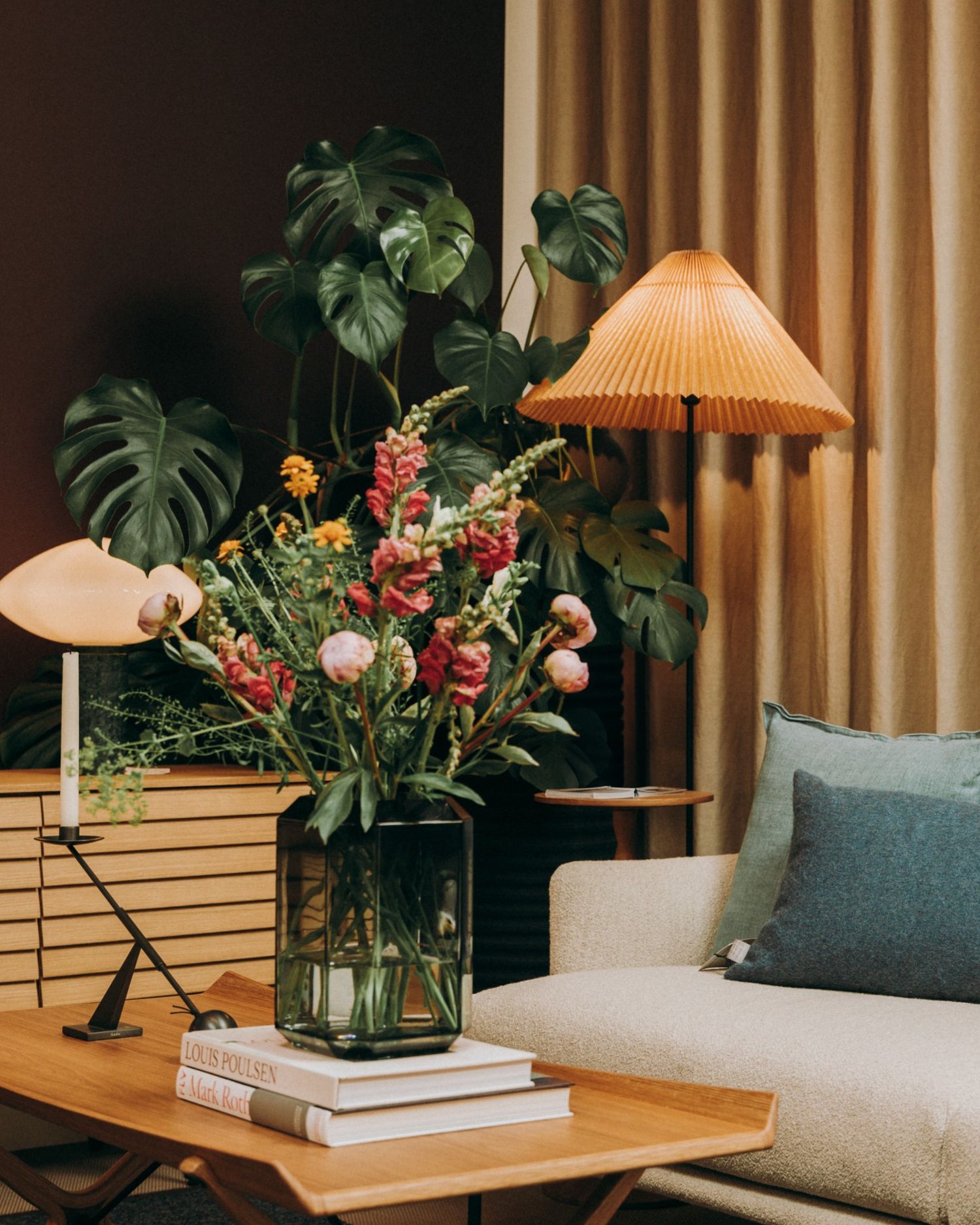 Nordic living room with monstera leaves, wooden coffee table, and floral vase in soft natural light — captured in Dublin by Sigi Photography