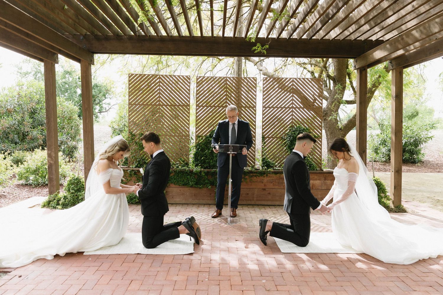 Panoramic view of a wedding first look sequence under a wooden pergola with natural lighting.