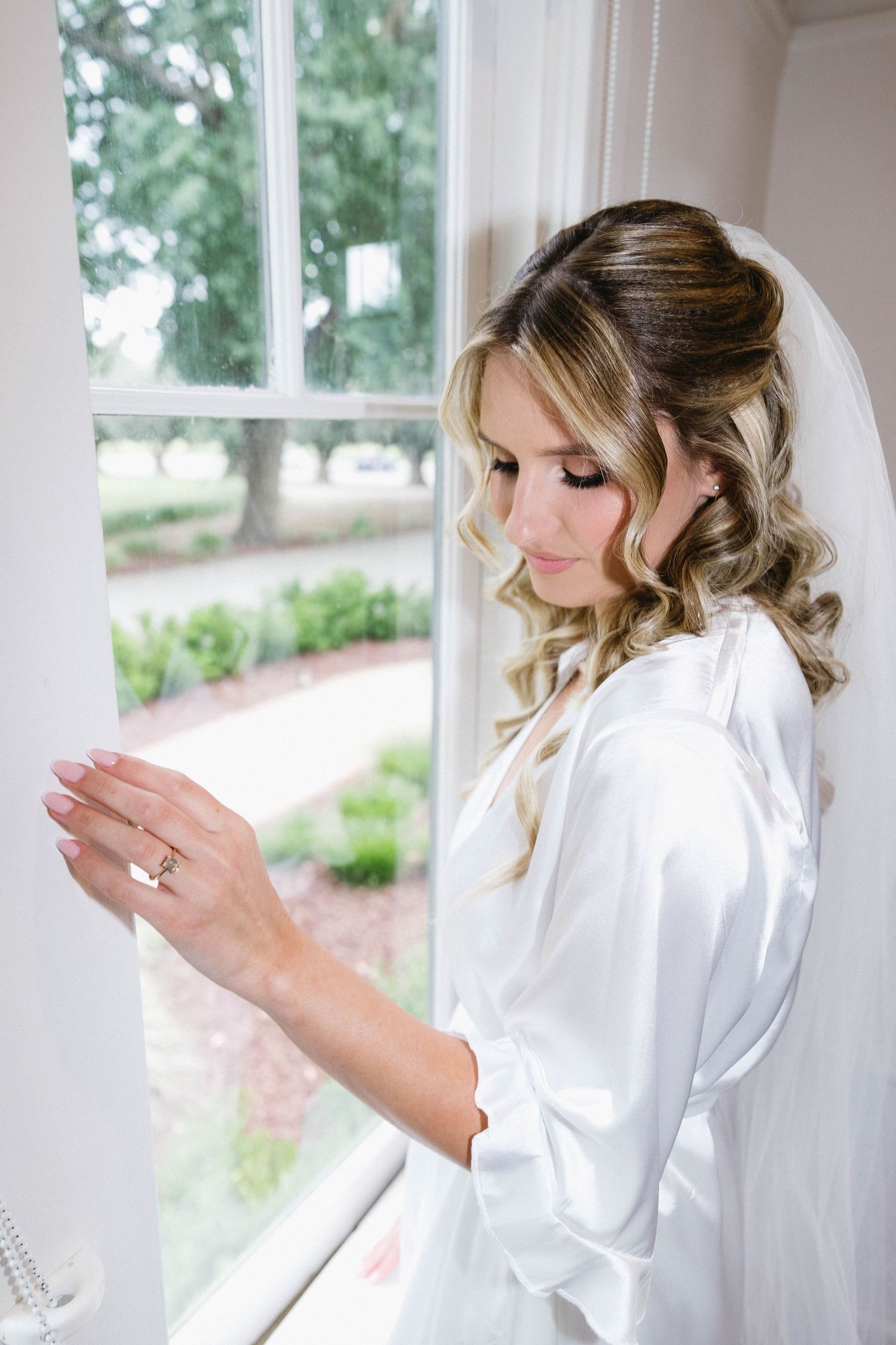 Getting ready wedding photos showing details of hair and makeup preparation.