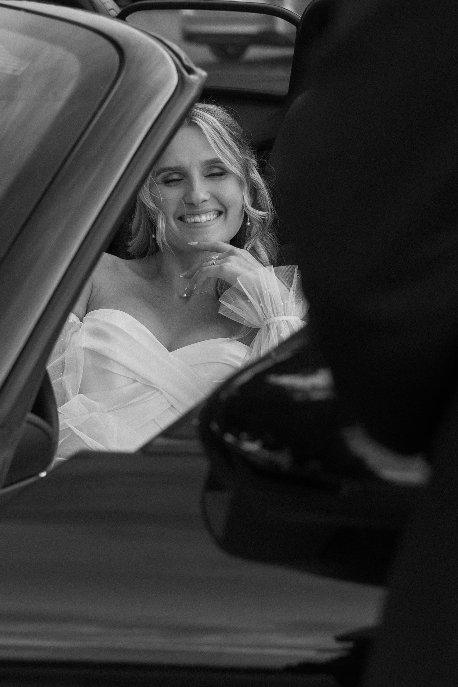 Black and white photos of a bride smiling in a luxury car.