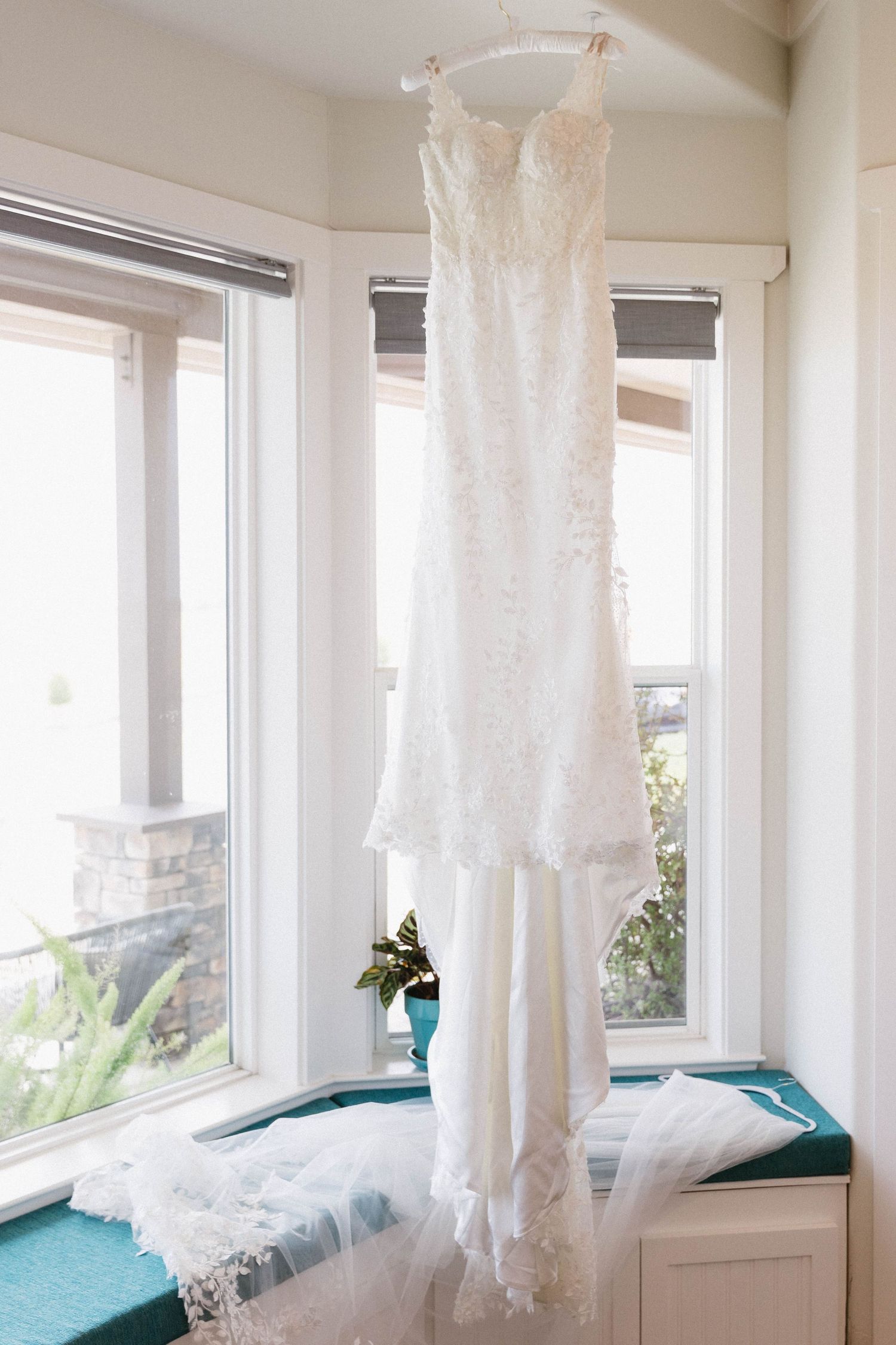 Sunlit room with sheer white curtains and window seats creating a bright, airy atmosphere.