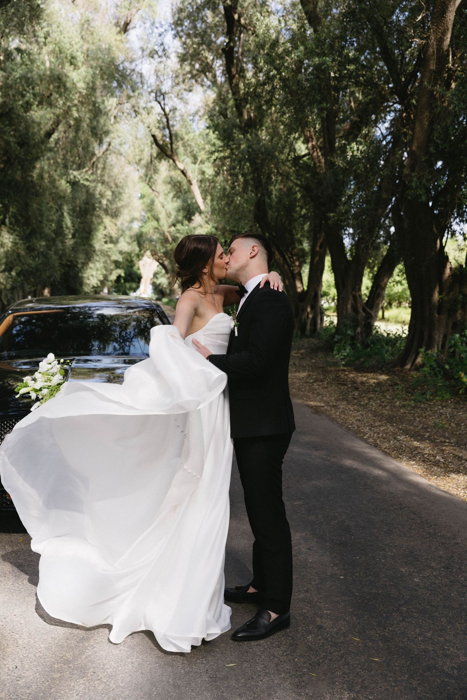 A romantic wedding dance sequence on a tree-lined path showing the couple in elegant spins and dips.