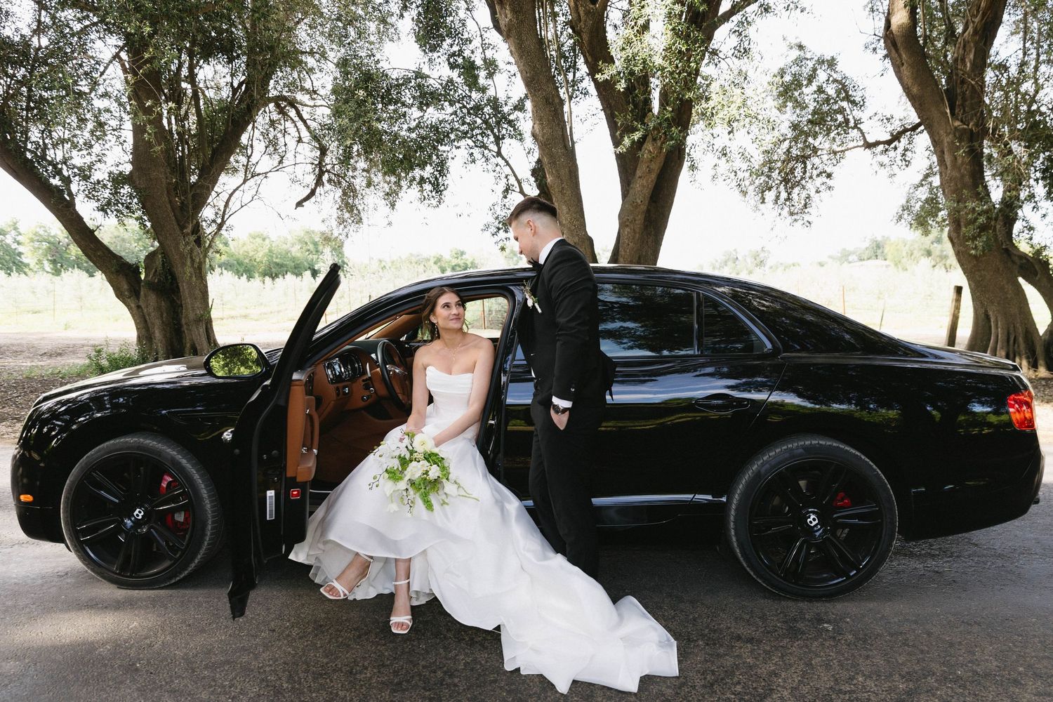 Elegant wedding photo sequence with a black luxury vehicle under shaded trees.