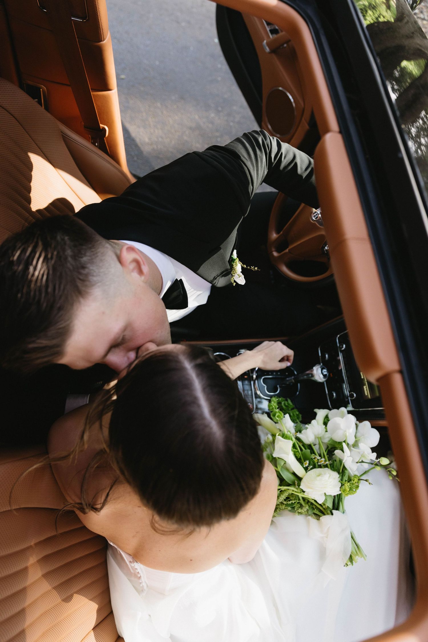 A series of photos showing a couple sharing an intimate kiss in the backseat of a car with tan leather interior.