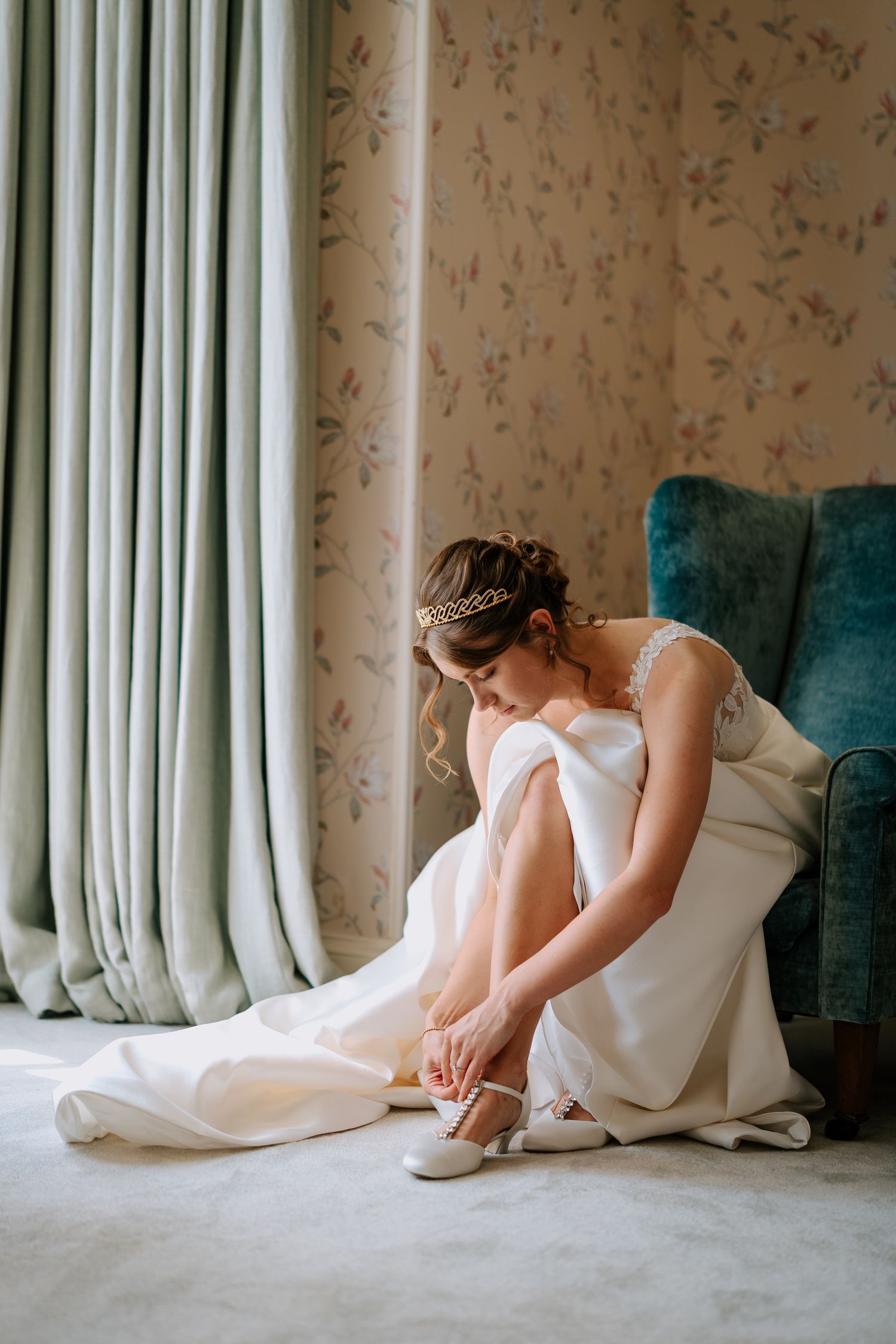Elegant bridal scene showing wedding dress details and ballet shoes.